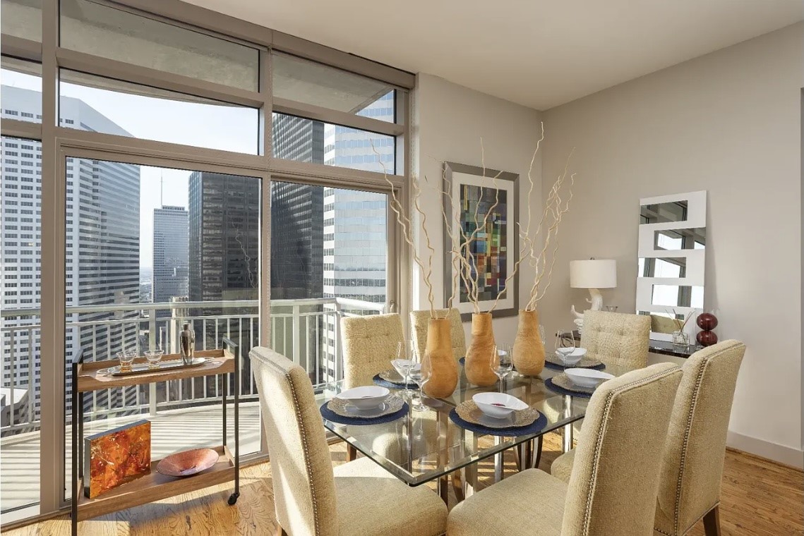 Enjoy every meal with breathtaking downtown views from the beautifully appointed dining area. Floor-to-ceiling windows flood the space with natural light while seamlessly connecting indoor living with the vibrant city skyline, creating the perfect setting for intimate dinners or entertaining guests.