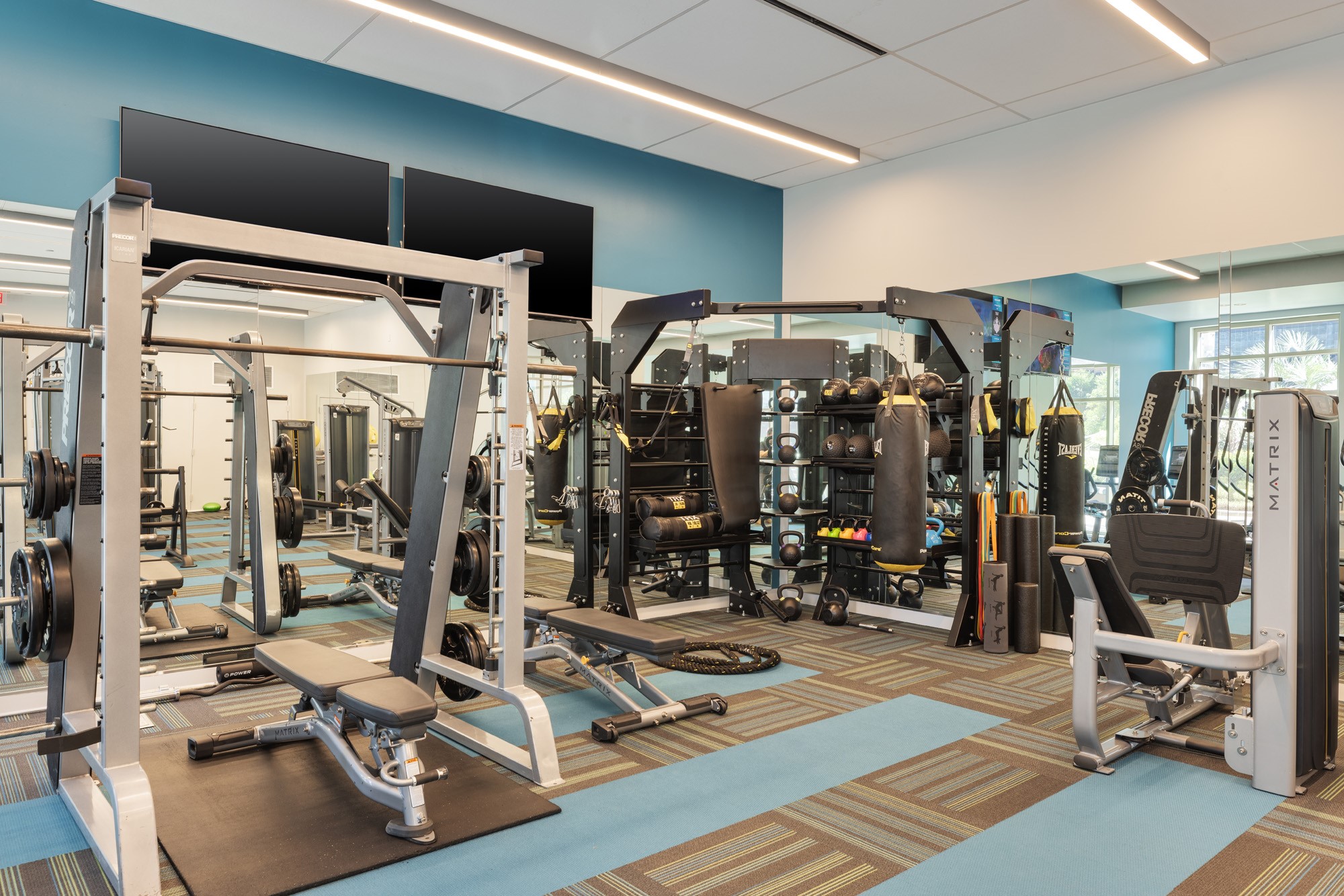 Designed for every fitness level, the dedicated strength-training area features squat racks, functional training stations, punching bags, resistance equipment, free weights, and performance-focused workout zones providing everything needed for both strength and conditioning routines.