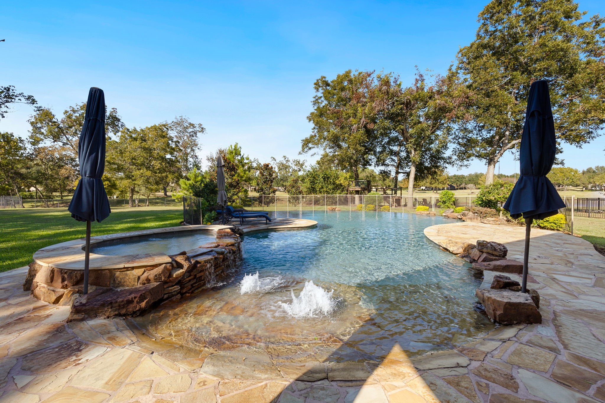 Zero entry, large hot tub, waterfall, and infinity edge pool really offer a retreat feel!