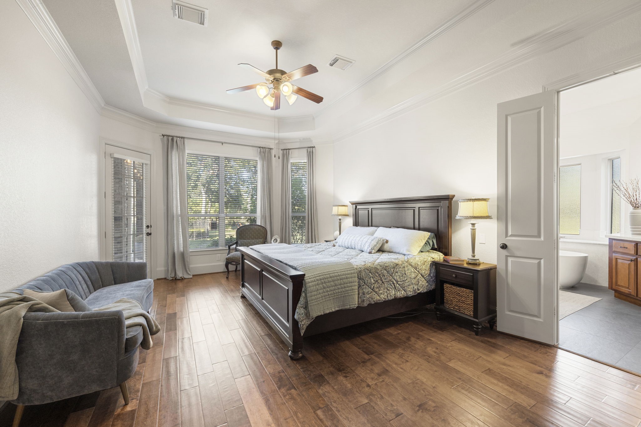 A true Primary Retreat awaits you featuring tall tray ceilings, fresh designer paint, rich wood floors, tons of natural light coming in from the Bay Window sitting area.