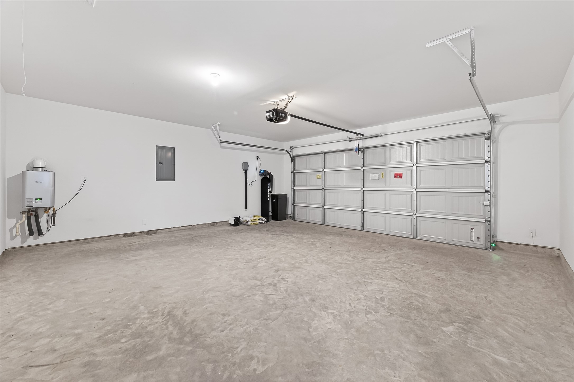 Garage featuring instant hot water heater, water softener system