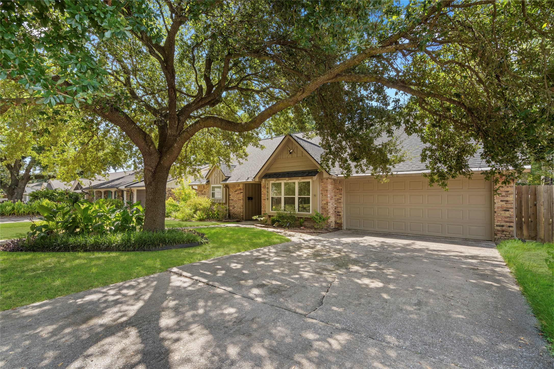 The long, wide driveway offers plenty of space for guests to park or an inviting space to greet neighbors.