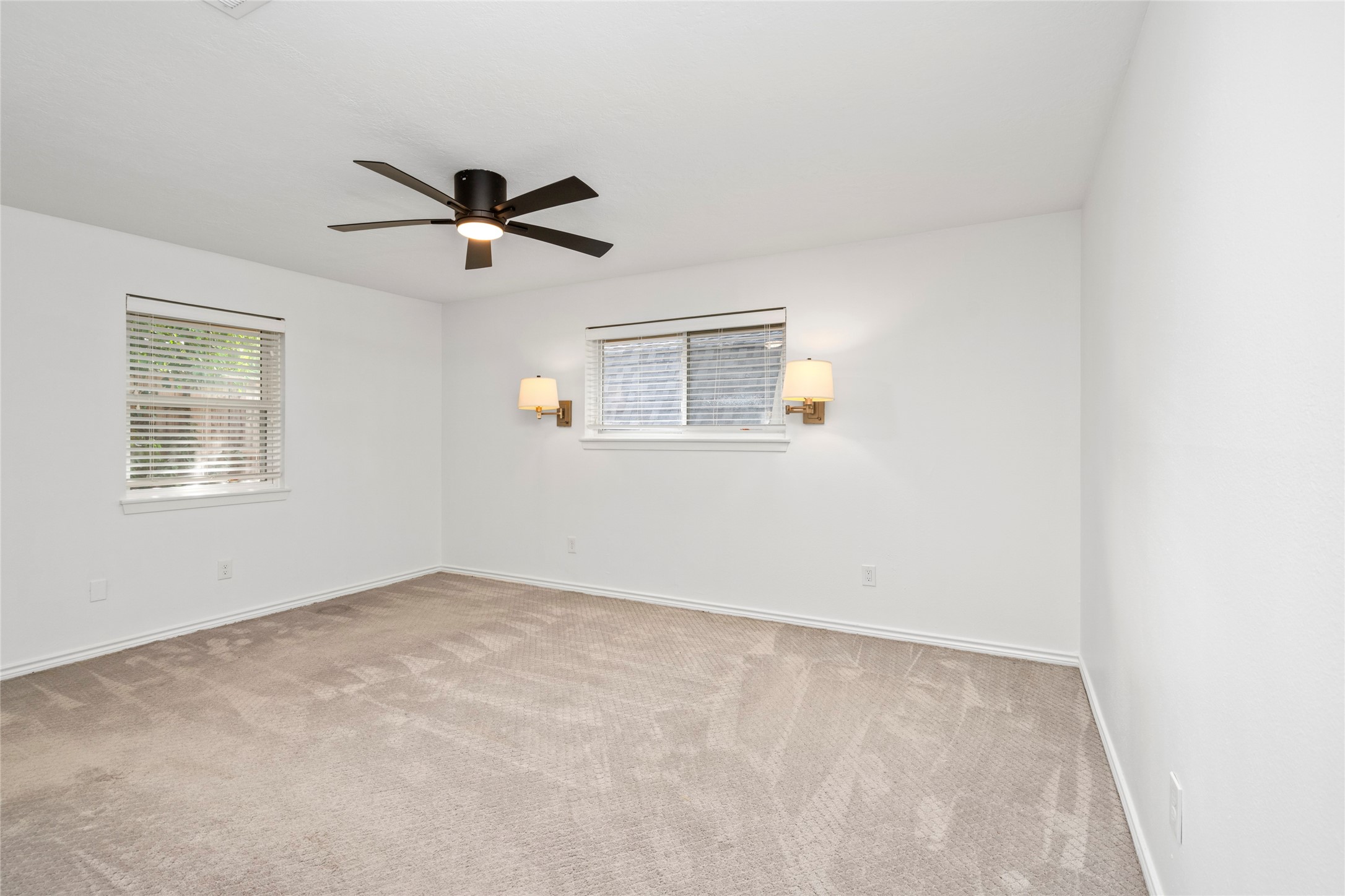 The primary bedroom sits at the back corner of the home offering privacy and a full ensuite