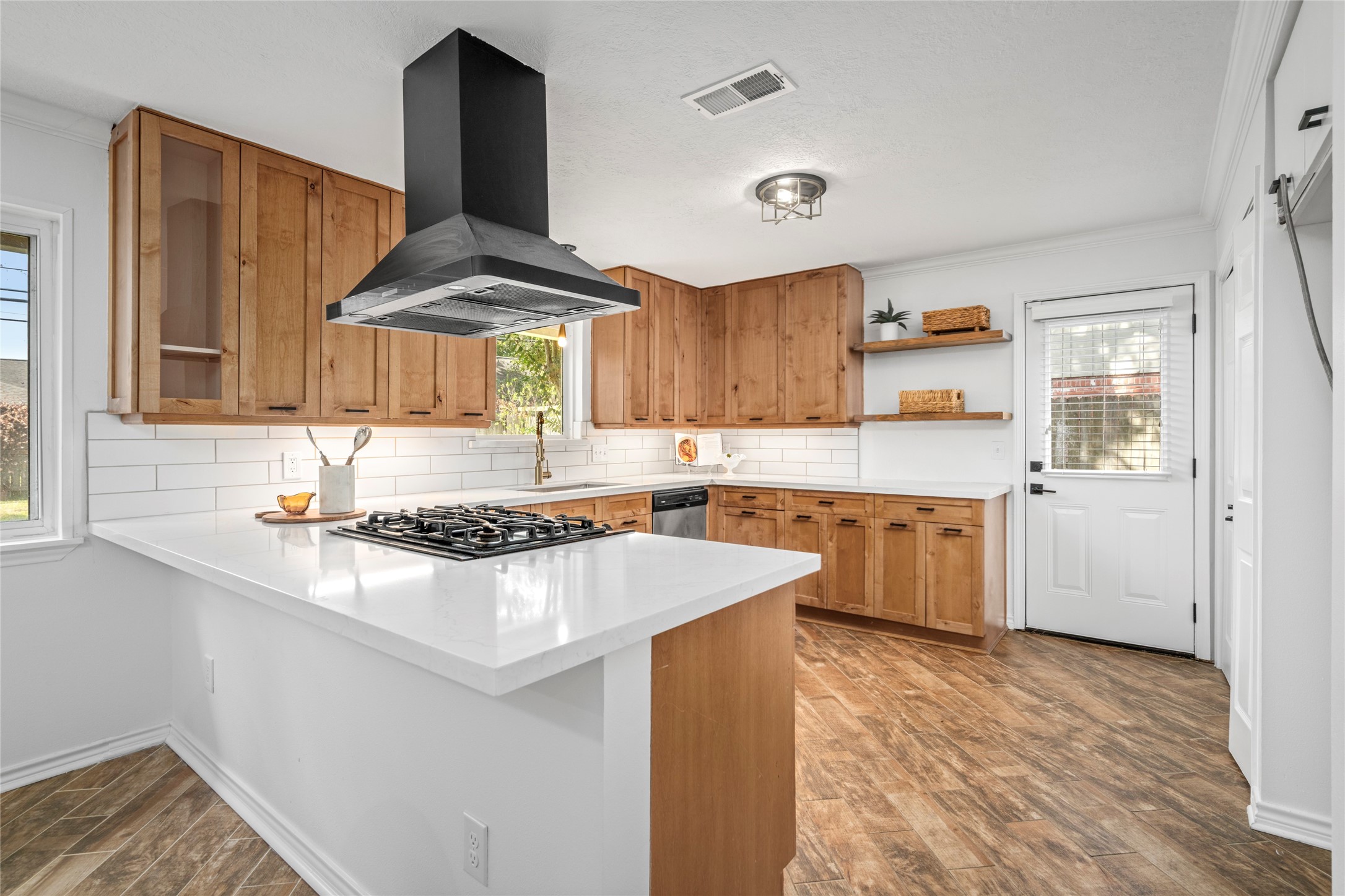 The open kitchen is a mid-modern dream. Access to the side yard for easy entertaining.