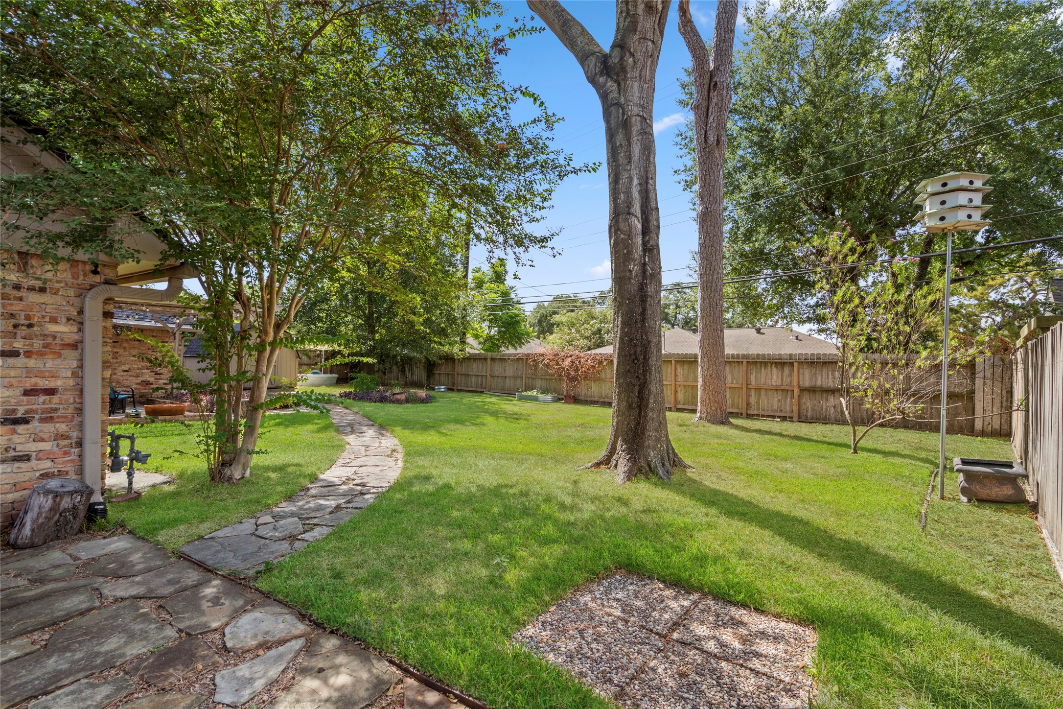 Well curated landscaping shines through every inch of this yard