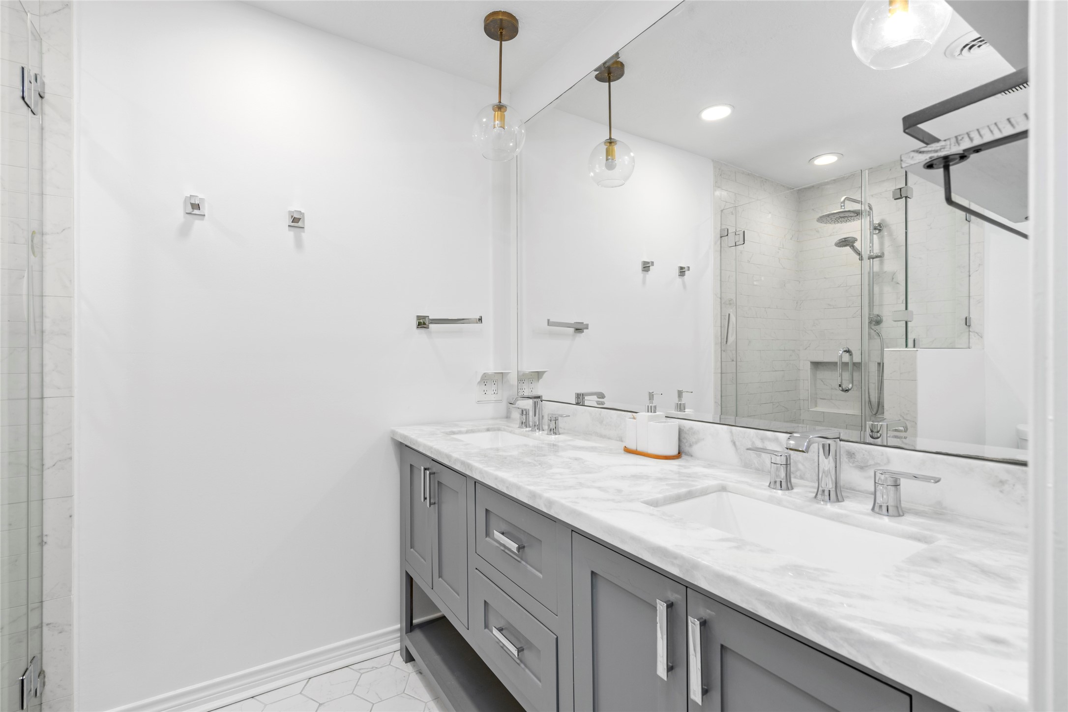 Primary ensuite includes updated fixtures, plenty of cabinets, and double sinks