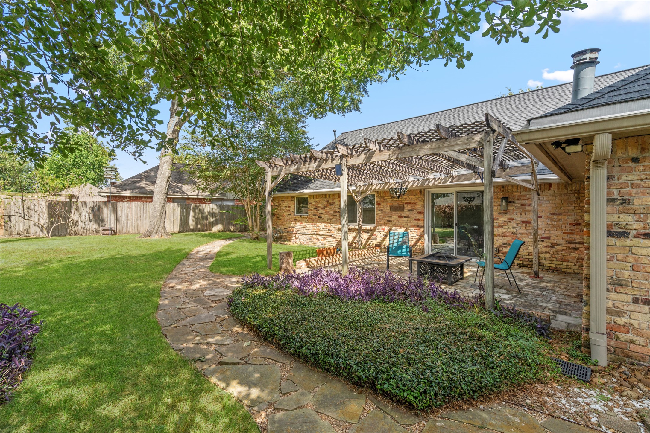 Mature landscaping, upgraded drainage, and thoughtful grading frame the exterior of the home