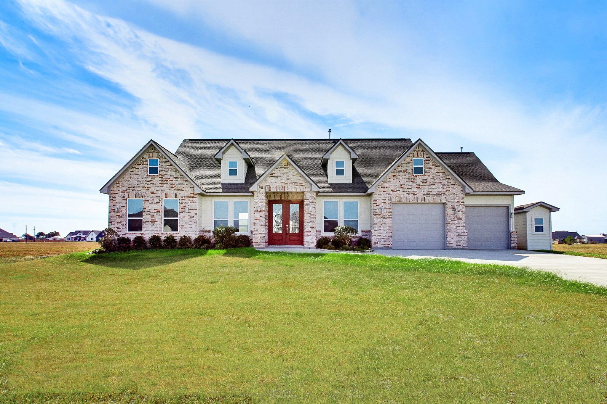 Charming 2389 sq.ft. brick 3-bedroom 549 sq.ft. 2 car garage home with a spacious 1 Acre lot, featuring a welcoming entrance and a two-car garage.