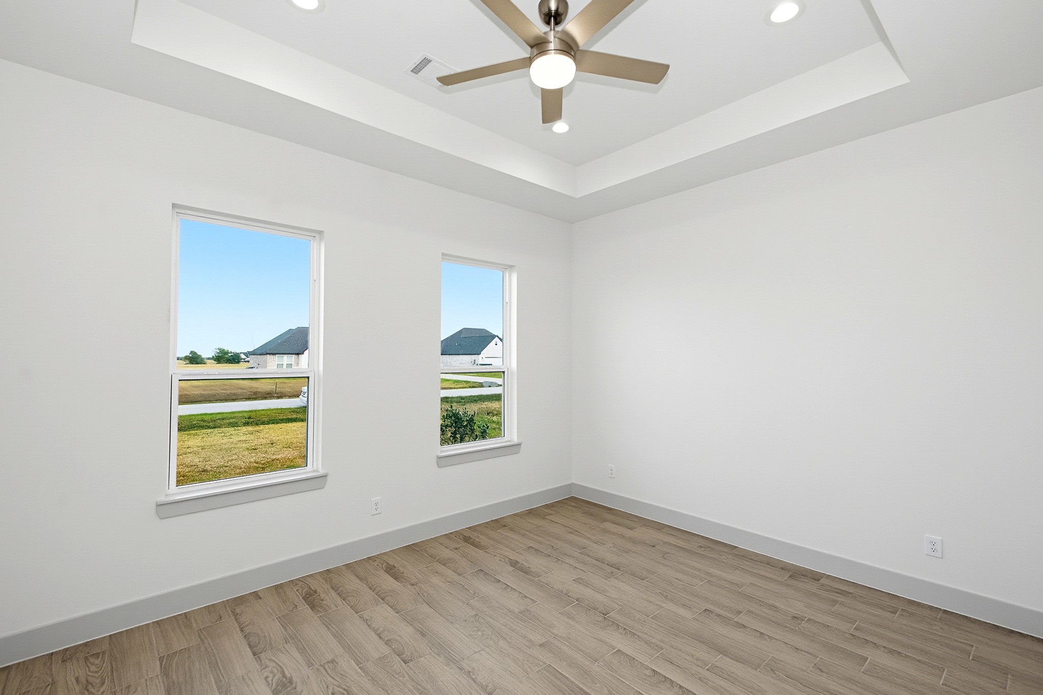 14.5 x 12 Second bedroom with tray ceiling, modern ceiling fan. large windows for natural sunlight and spacious closet.