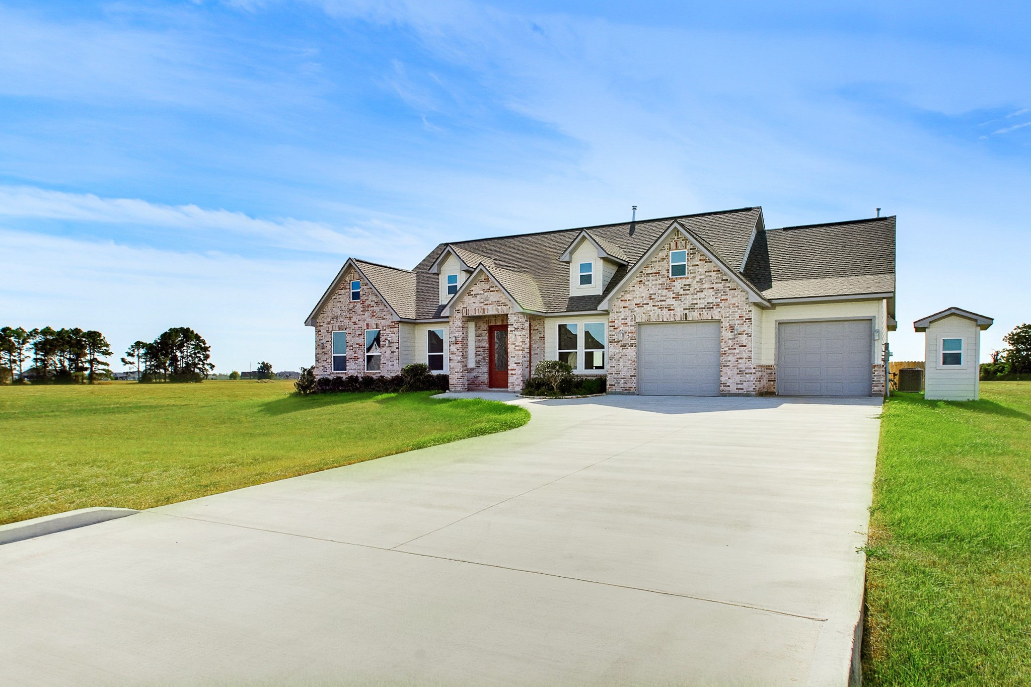 Charming 2389 sq.ft. brick home with a spacious double driveway, 549 sq.ft. dual garages, and expansive green one acre lawn, offering a perfect blend of comfort and style in a serene Bar X Ranch setting.