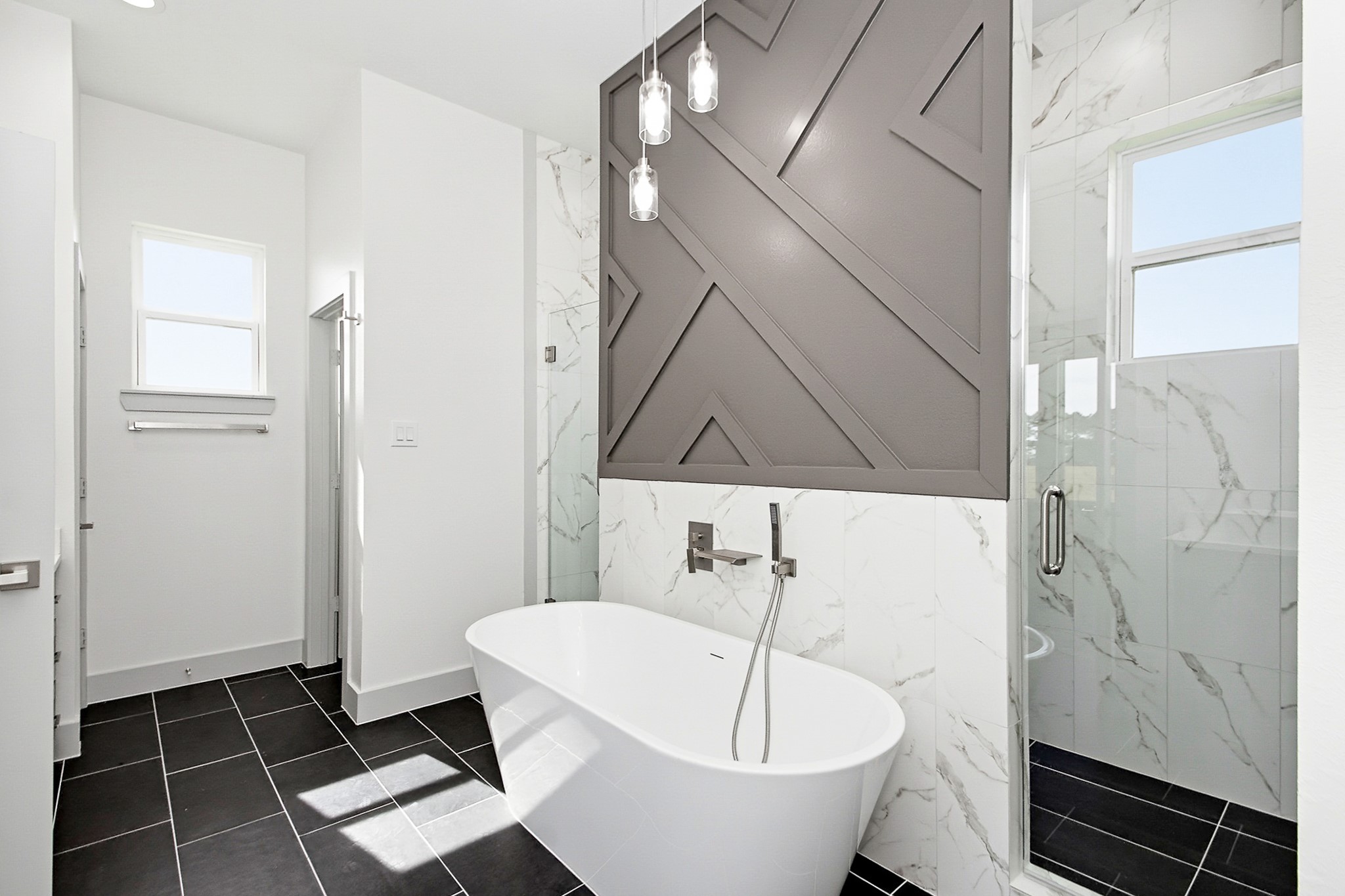 Luxurious 16x12 bathroom featuring a sleek freestanding tub, modern tile accents, and a spacious glass-enclosed shower for a spa-like experience.