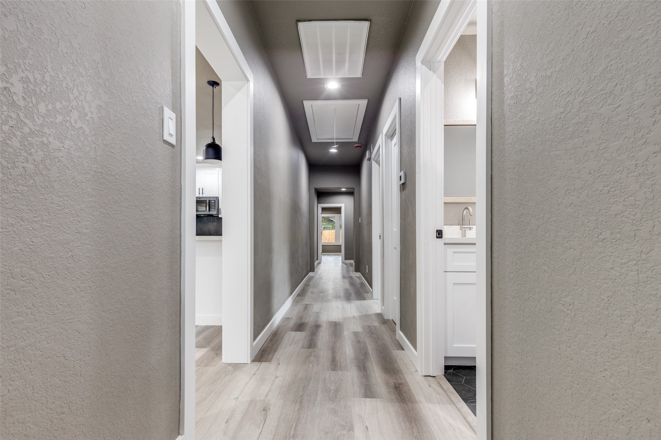 Bright hallway with clean new finishes and recessed lighting, giving the home an airy, move in ready feel. Bright hallway with clean new finishes and recessed lighting, giving the home an airy, move in ready feel.