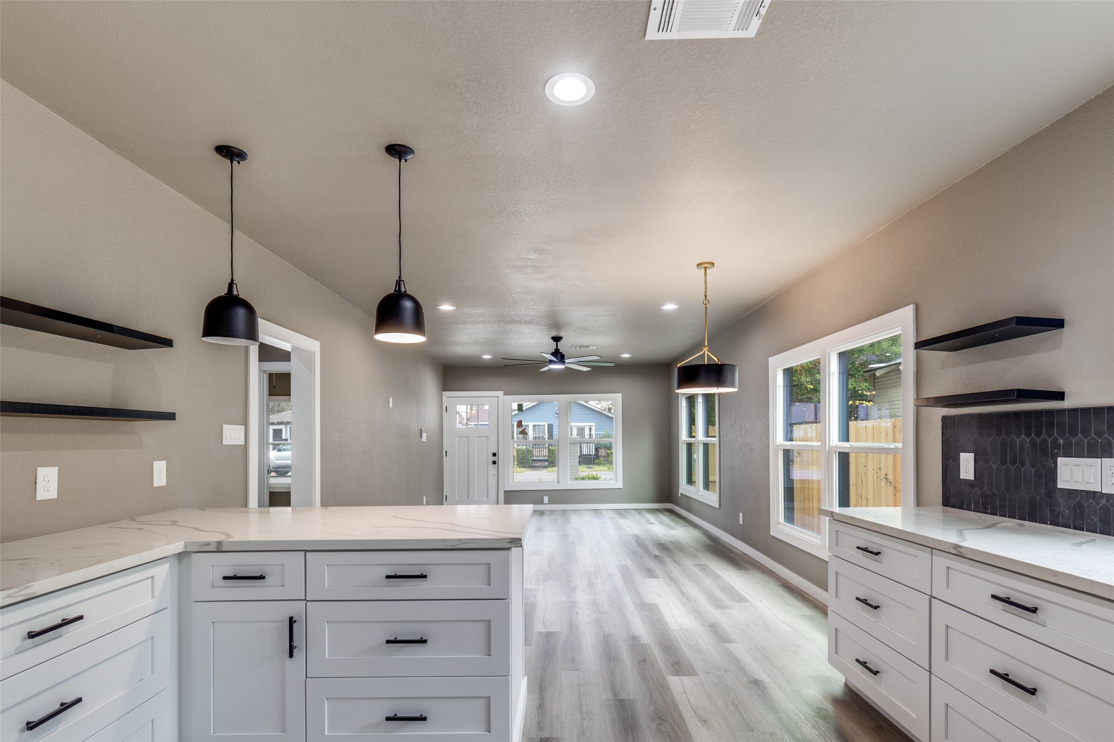 Open concept flow into the kitchen with quartz counters, black stainless steel appliances, and a peninsula that keeps everyone together. Open concept flow into the kitchen with quartz counters, black stainless steel appliances, and a peninsula that keeps everyone together.