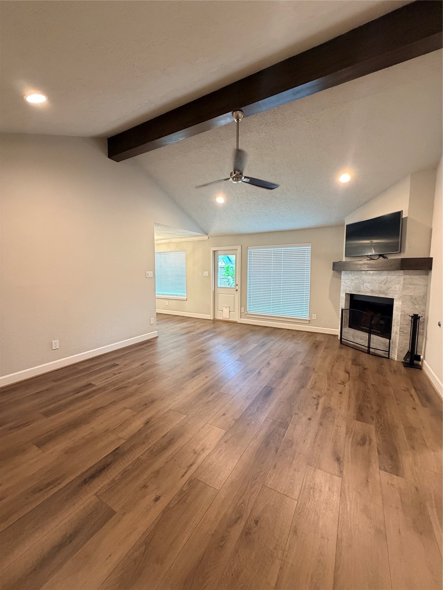 Spacious living area with stained wood beam