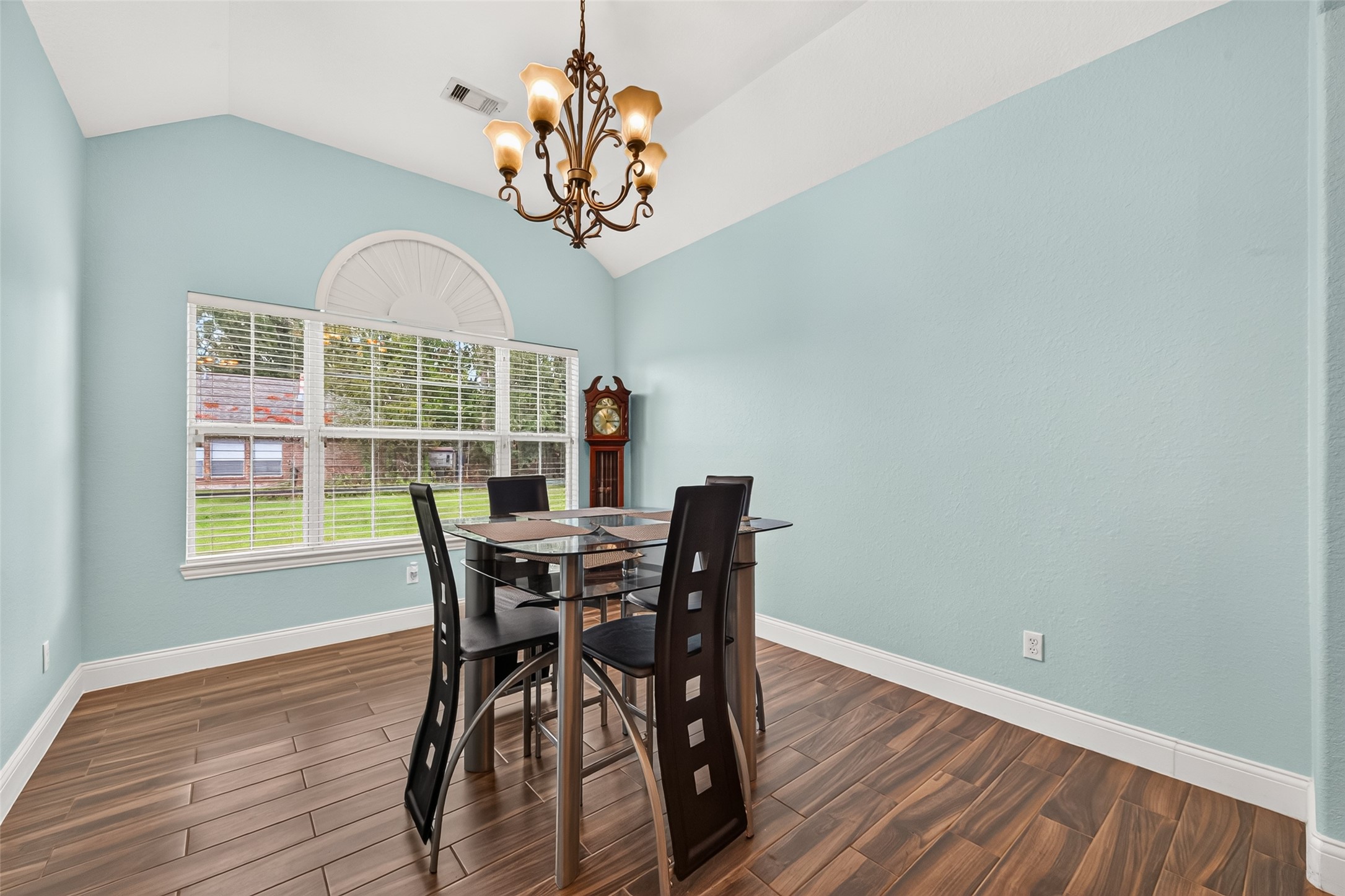 Enjoy gatherings in this spacious formal dining room, complete with a decorative chandelier and large windows overlooking the front yard.