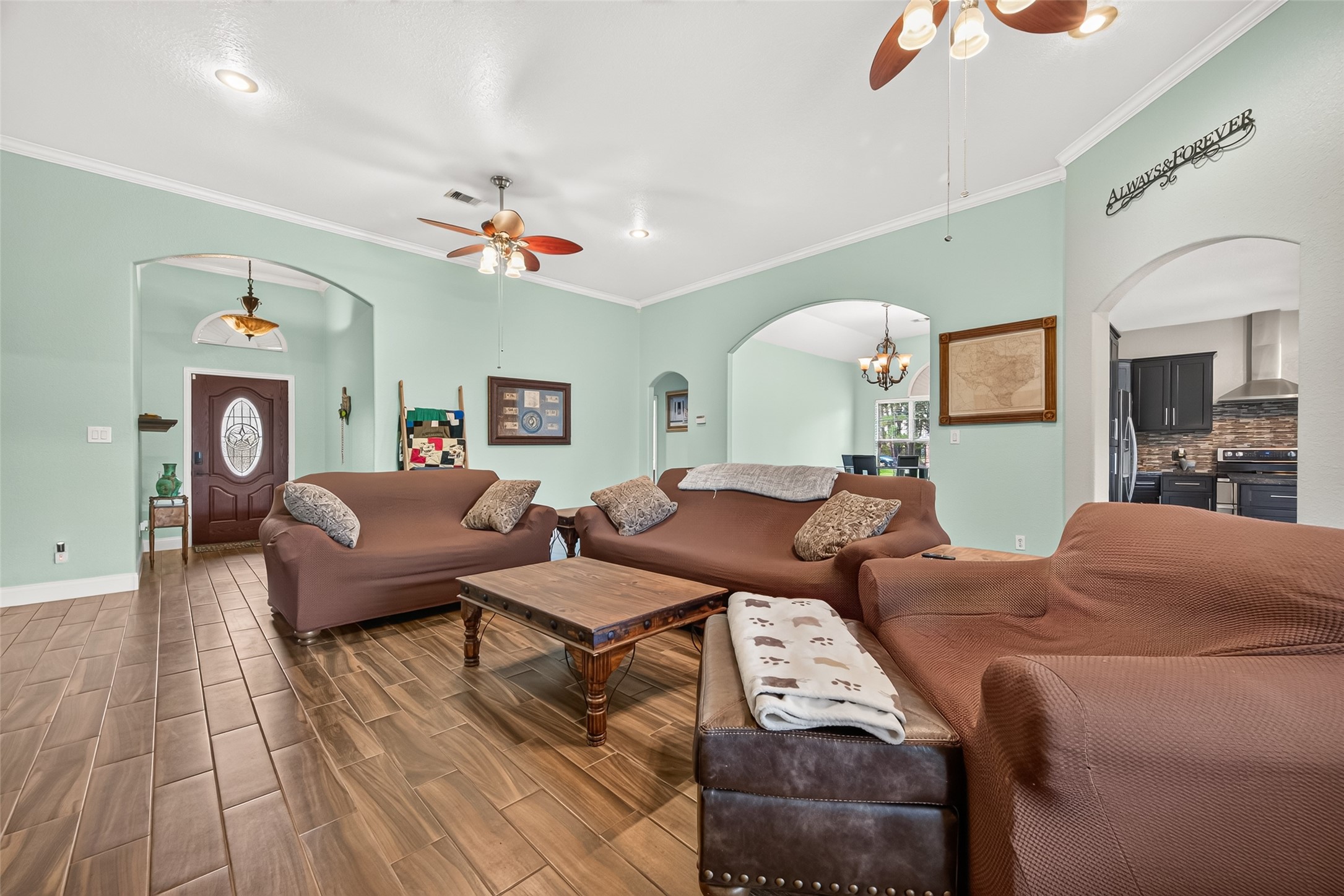 njoy the spacious feel of this inviting living area, featuring beautiful flooring, architectural archways, and an open layout ideal for gatherings.