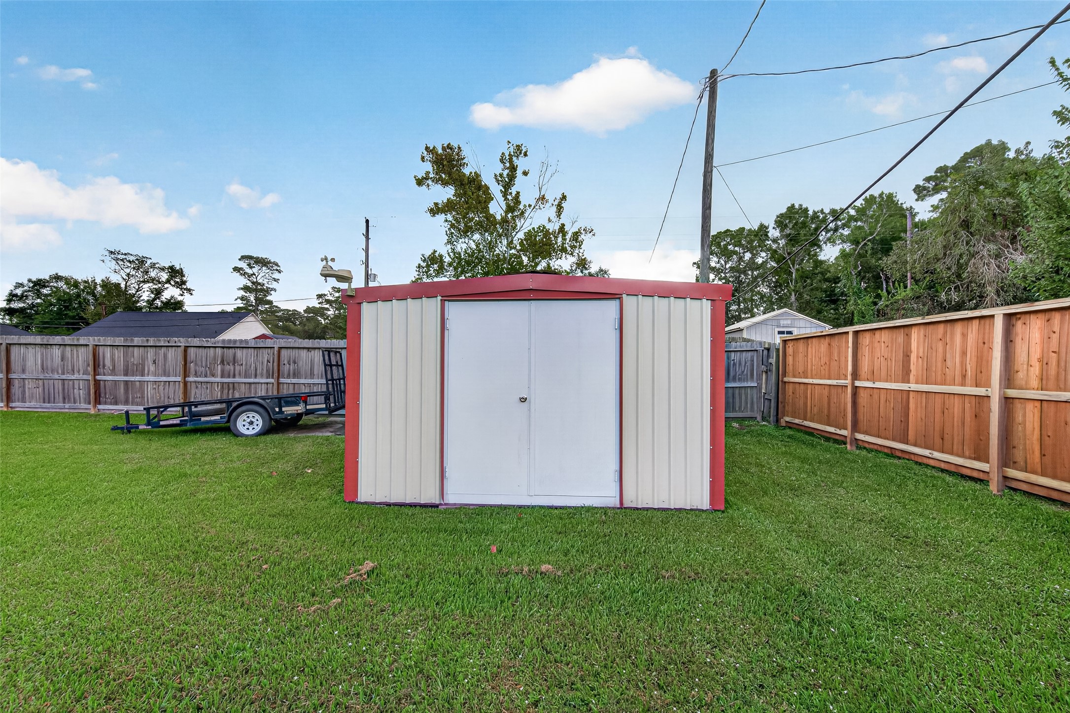 Additional backyard storage! This detached storage shed provides convenient space for lawn equipment, gardening tools, and outdoor essentials.
