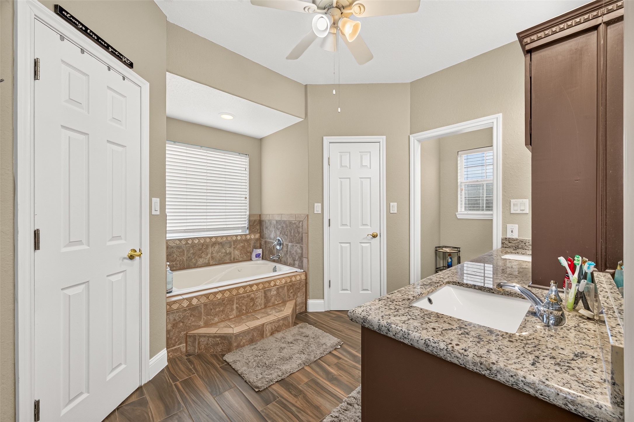 Spacious primary bathroom featuring a relaxing soaking tub, separate shower, and double-sink vanity with generous counter space.