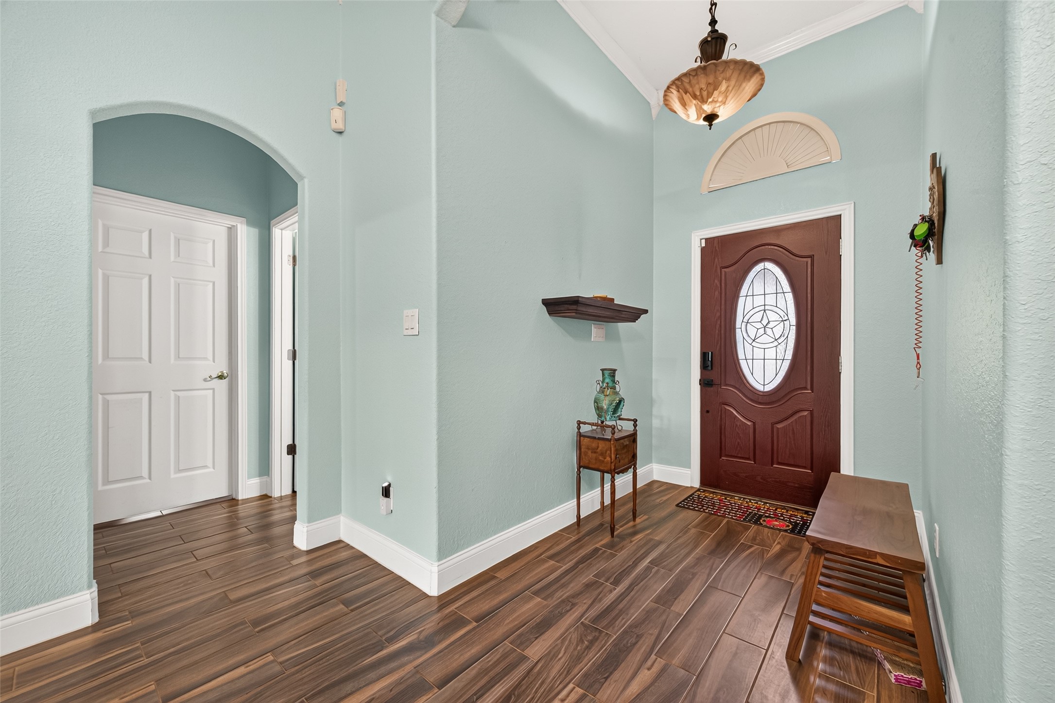 Charming architectural details, including arched openings and decorative trim, add character to this inviting entryway.