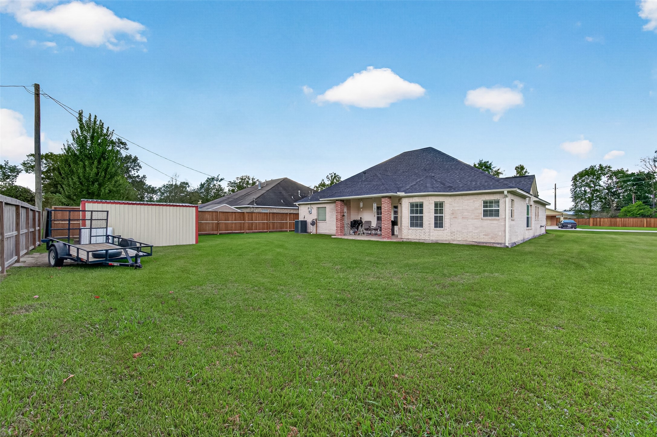 Look at all that room! This expansive, fully fenced backyard offers endless possibilities for outdoor entertaining, gardening, or simply enjoying the outdoors.