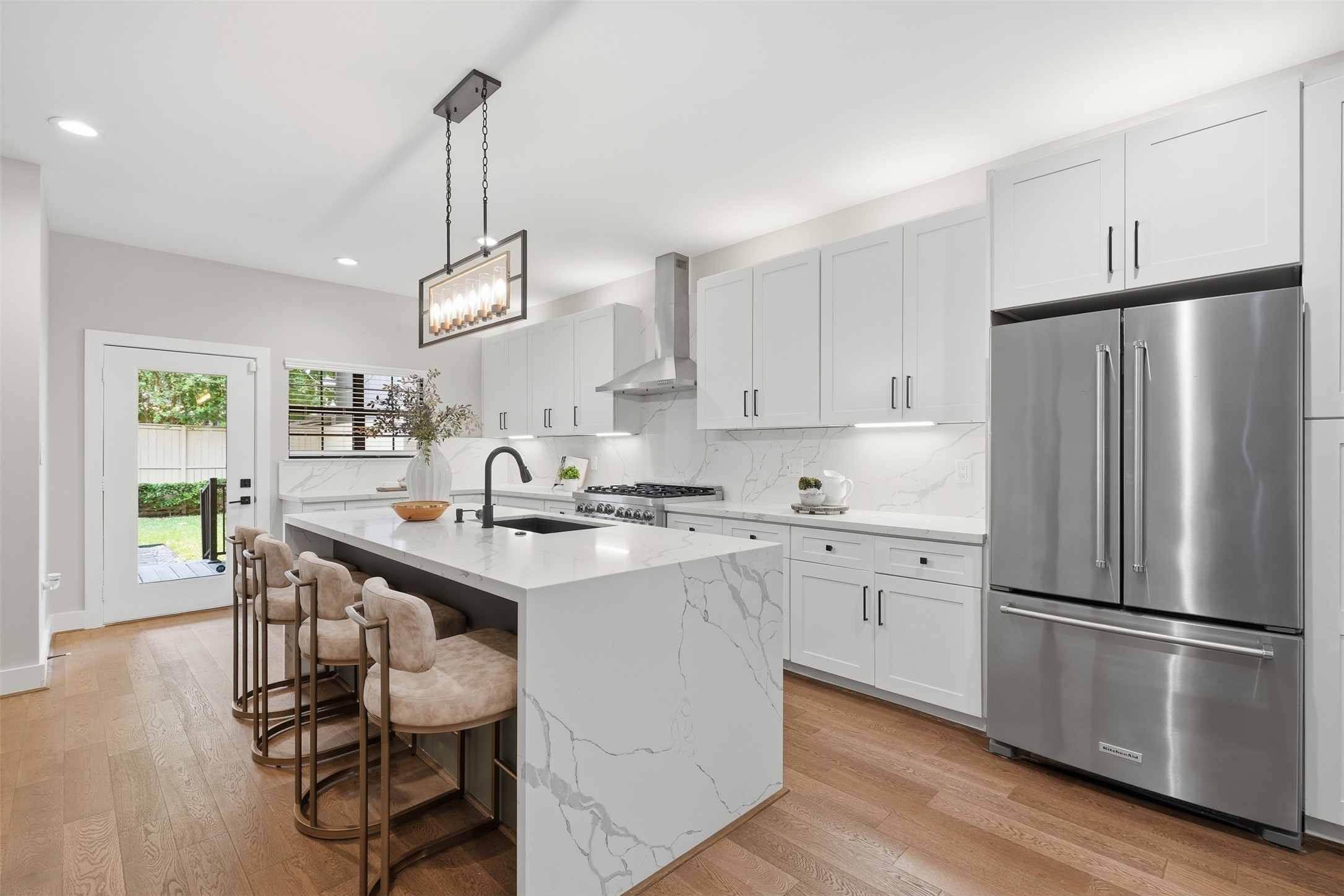 Stunning remodeled kitchen with quartz countertops and a waterfall island