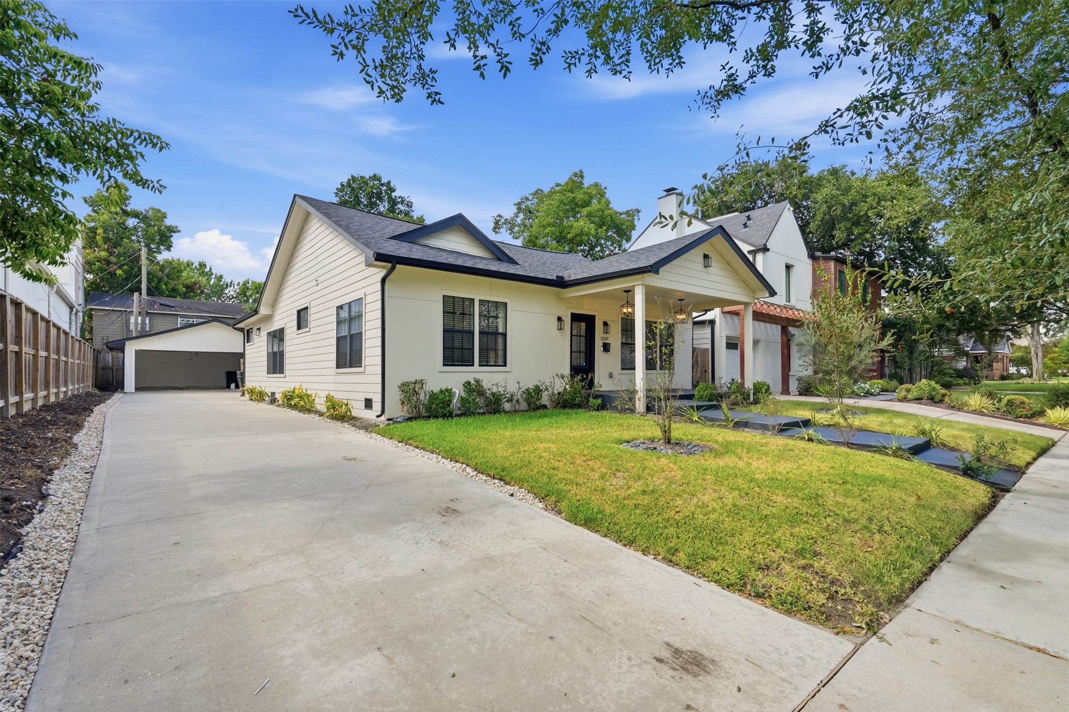 Charming curb appeal with an extended driveway and welcoming front porch
