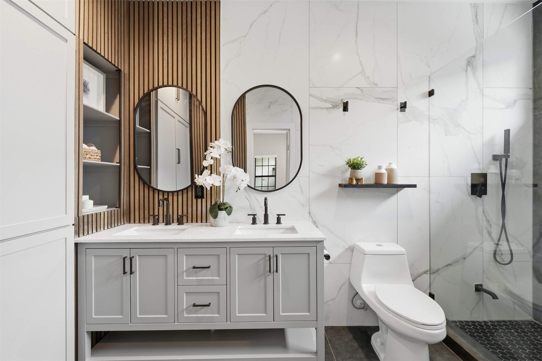 Luxurious bathroom featuring a double vanity and designer walk-in shower