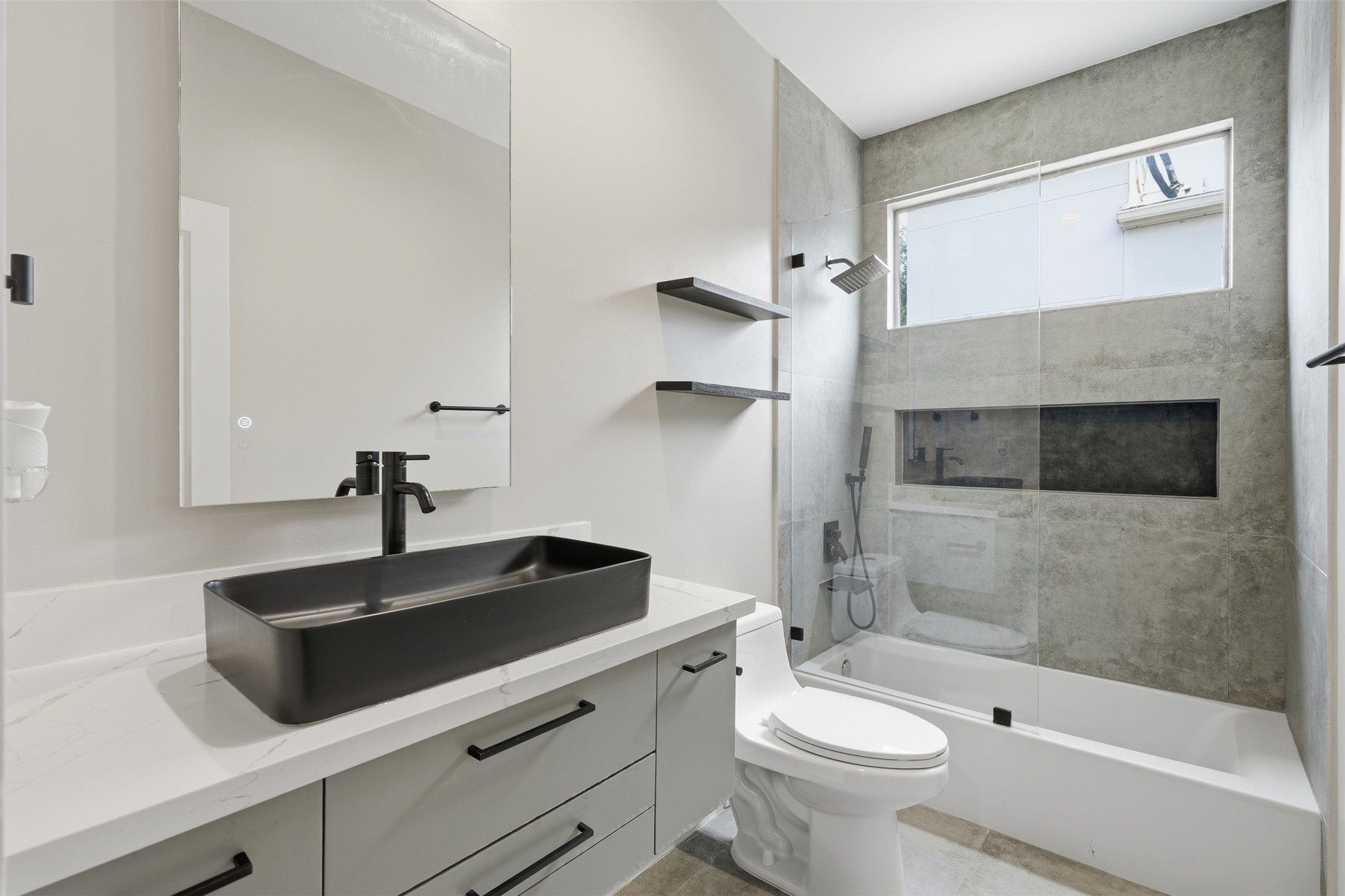 Beautifully renovated bathroom with modern fixtures and designer tilework