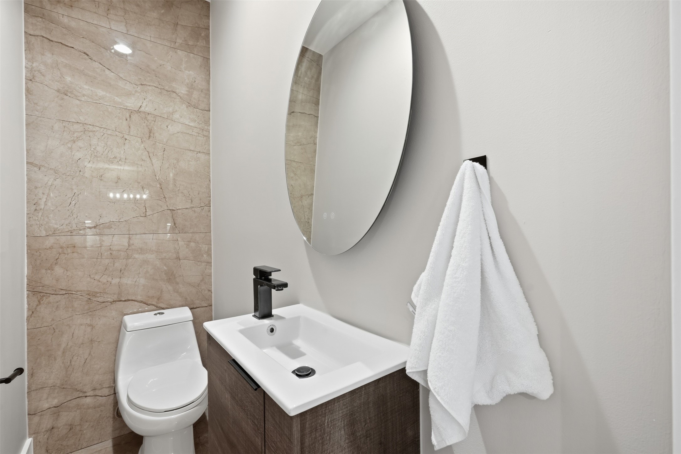 Chic powder room with contemporary fixtures and stylish accent tile.