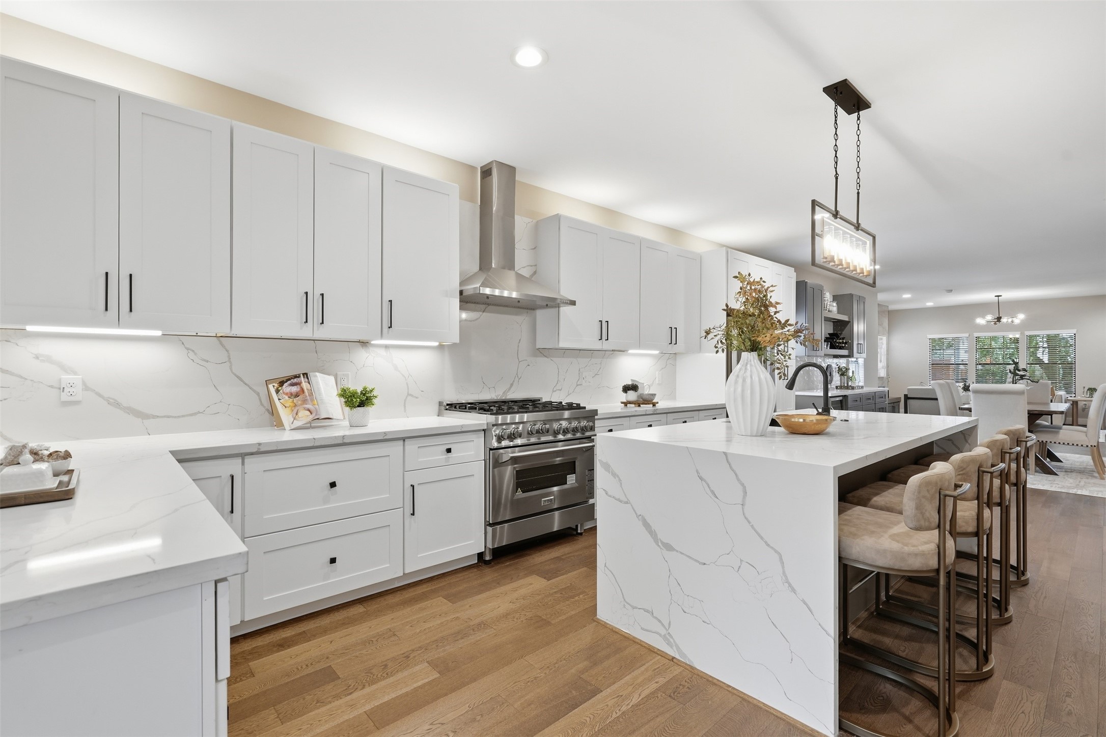 Sleek cabinetry, stainless-steel appliances, and designer finishes complete this kitchen