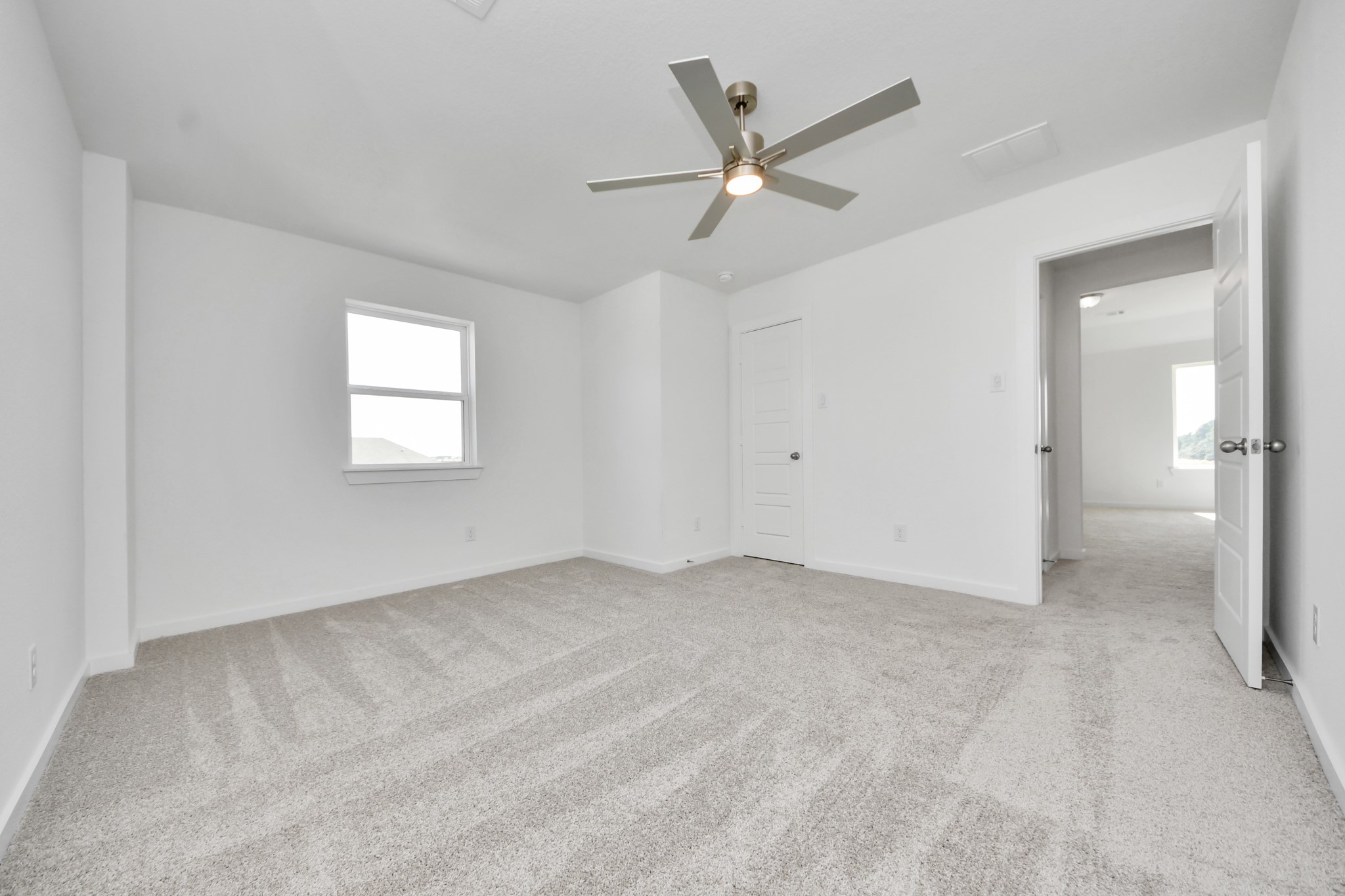 Generously sized secondary bedrooms featuring spacious closets, soft and inviting carpeting underfoot, large windows allowing plenty of natural light, and the added touch of privacy blinds for your personal retreat.