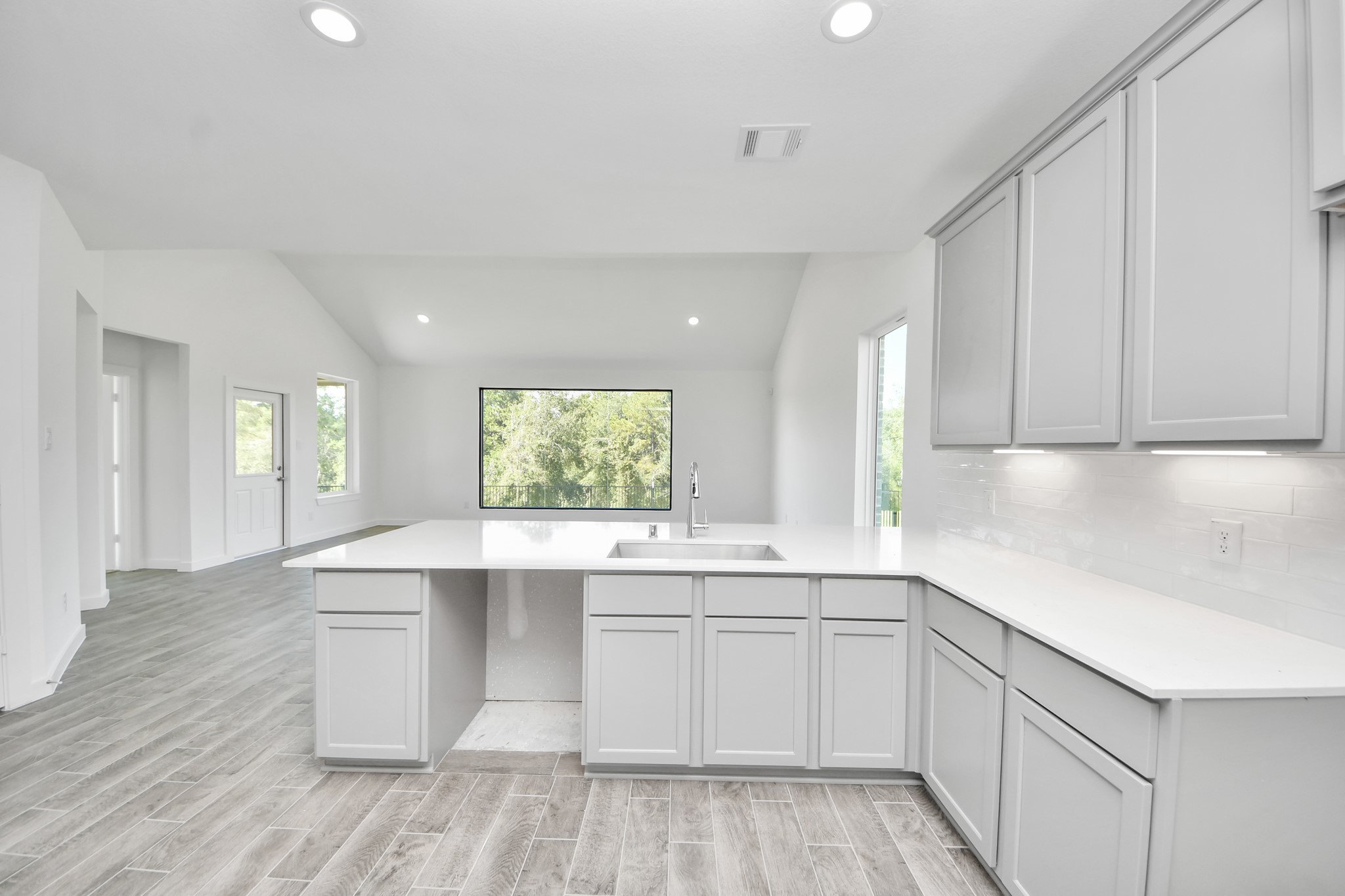 All of this overlooks your expansive family room, creating a perfect space for culinary delights and family gatherings.
