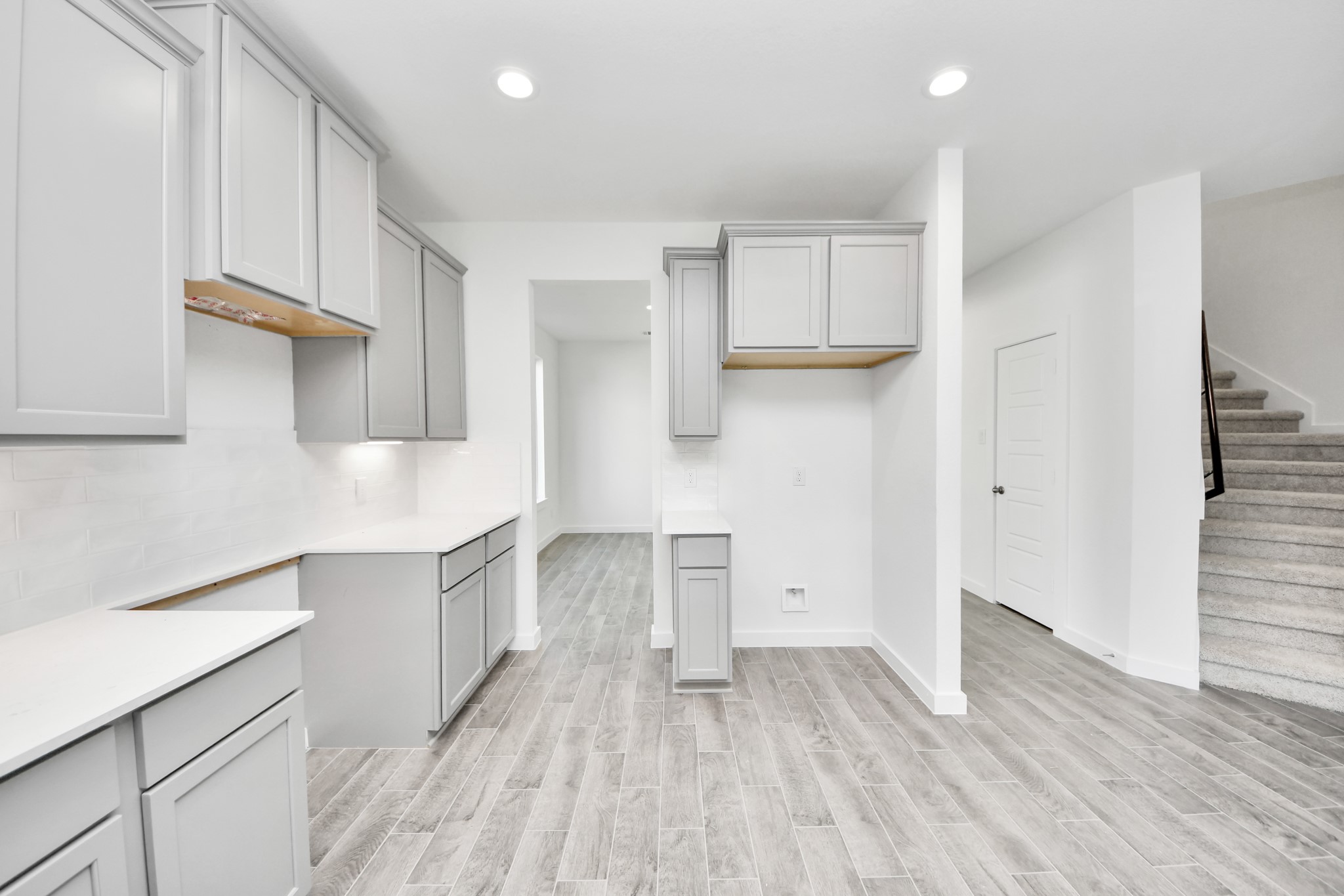 The open concept effortlessly connects the kitchen to the expansive family room, forming a perfect hub for gatherings. This seamless flow creates an inviting space where cooking and socializing come together harmoniously.