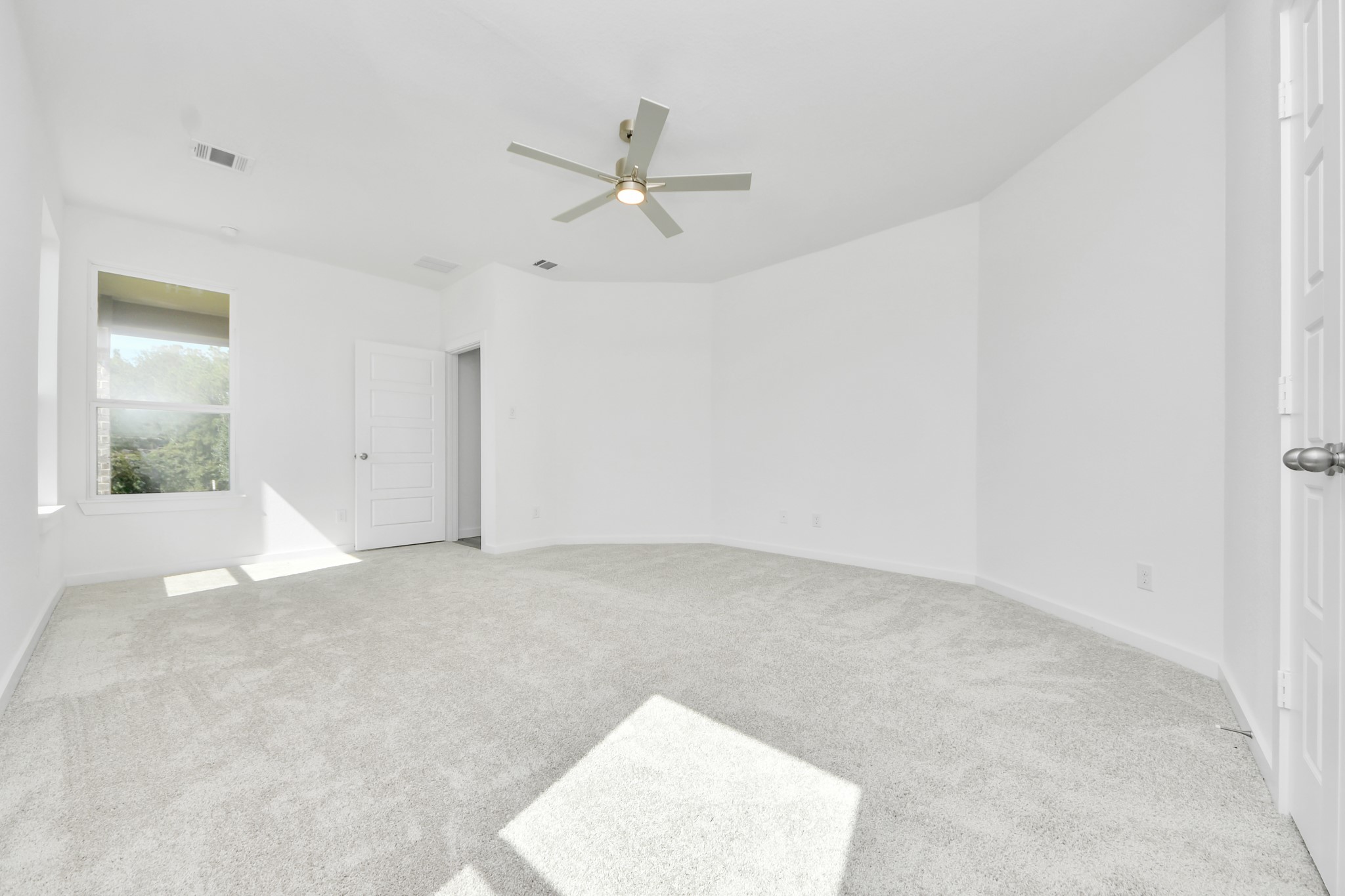 Retreat to the luxurious primary suite, your perfect escape for unwinding after a long day. Located on the first floor, this spacious room features plush carpeting, calming paint tones, high ceilings, and large windows with privacy blinds.