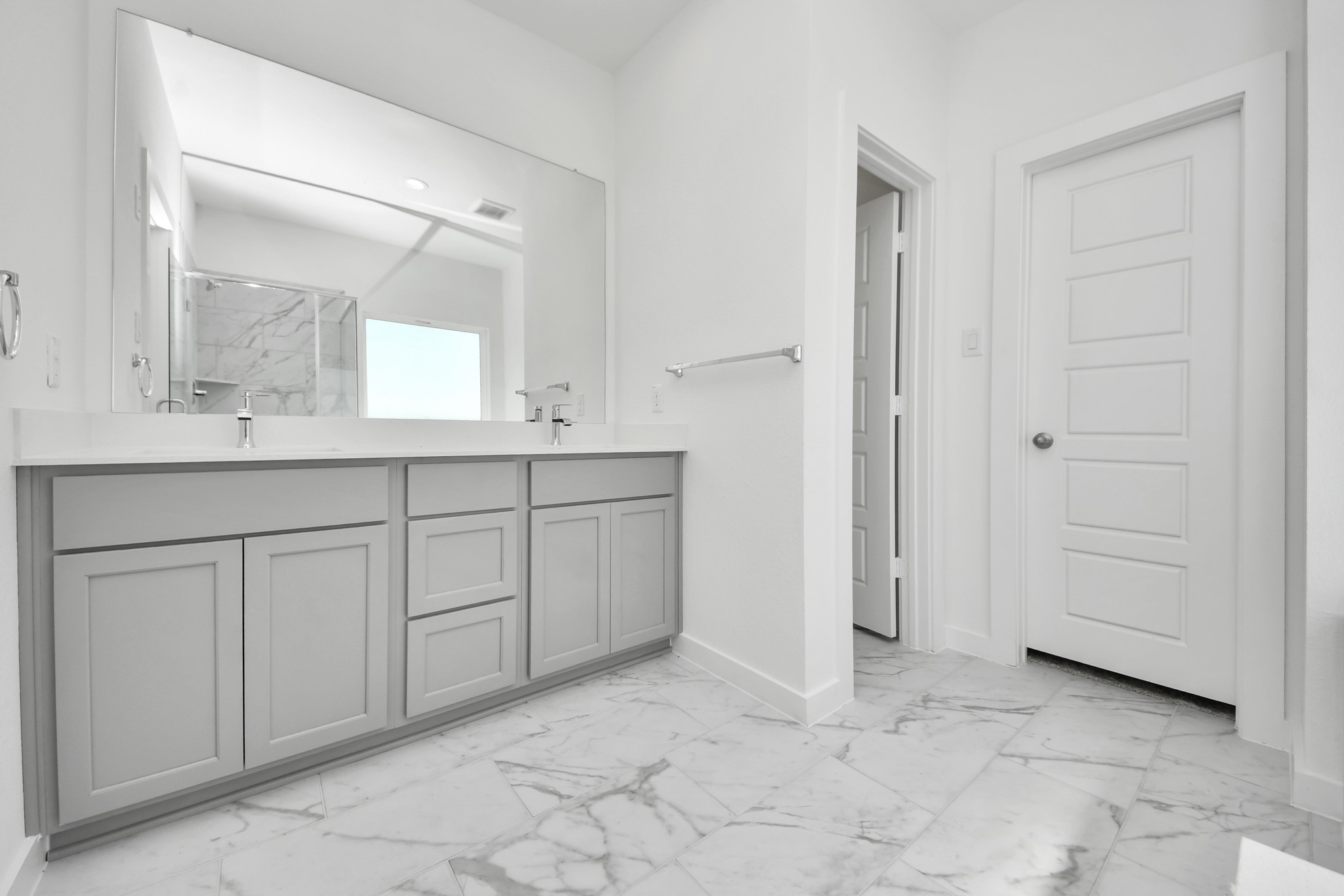 Escape to a spa-like oasis in this primary bathroom. Enjoy a walk-in shower with tile surround, a separate garden tub with custom detailing, and an elegant vanity featuring light countertops, modern hardware, and beautiful vanity lights. Experience luxury and relaxation in every detail.