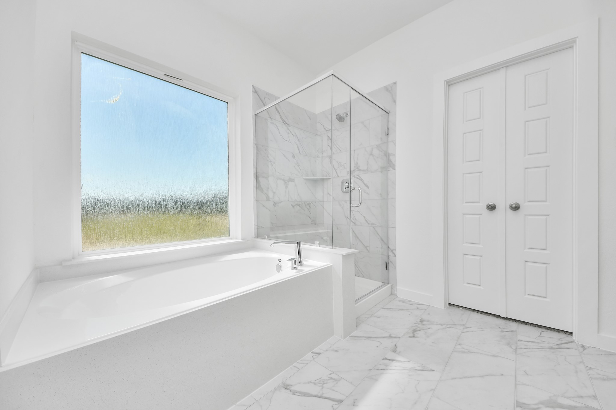 Indulge in a spa-like retreat within the confines of this primary bathroom. Delight in a spacious walk-in shower enveloped in stylish tile surround, unwind in a separate garden tub adorned with custom detailing.