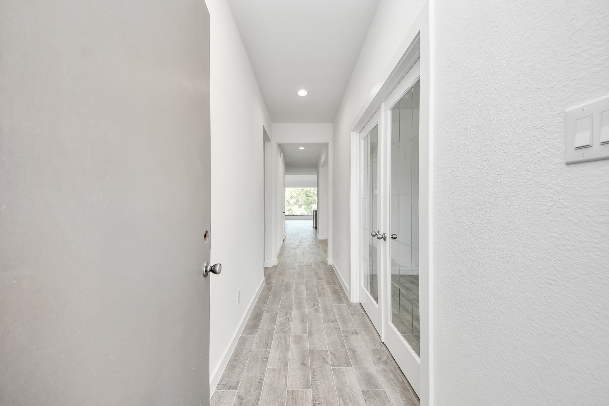 As you step into the threshold of this luxurious home, you'll soon be welcomed by an elegant glass door (to be installed). Inside, soaring ceilings amplify the spaciousness, while the refined wood-look tile flooring and oversized baseboards exude sophistication and charm.