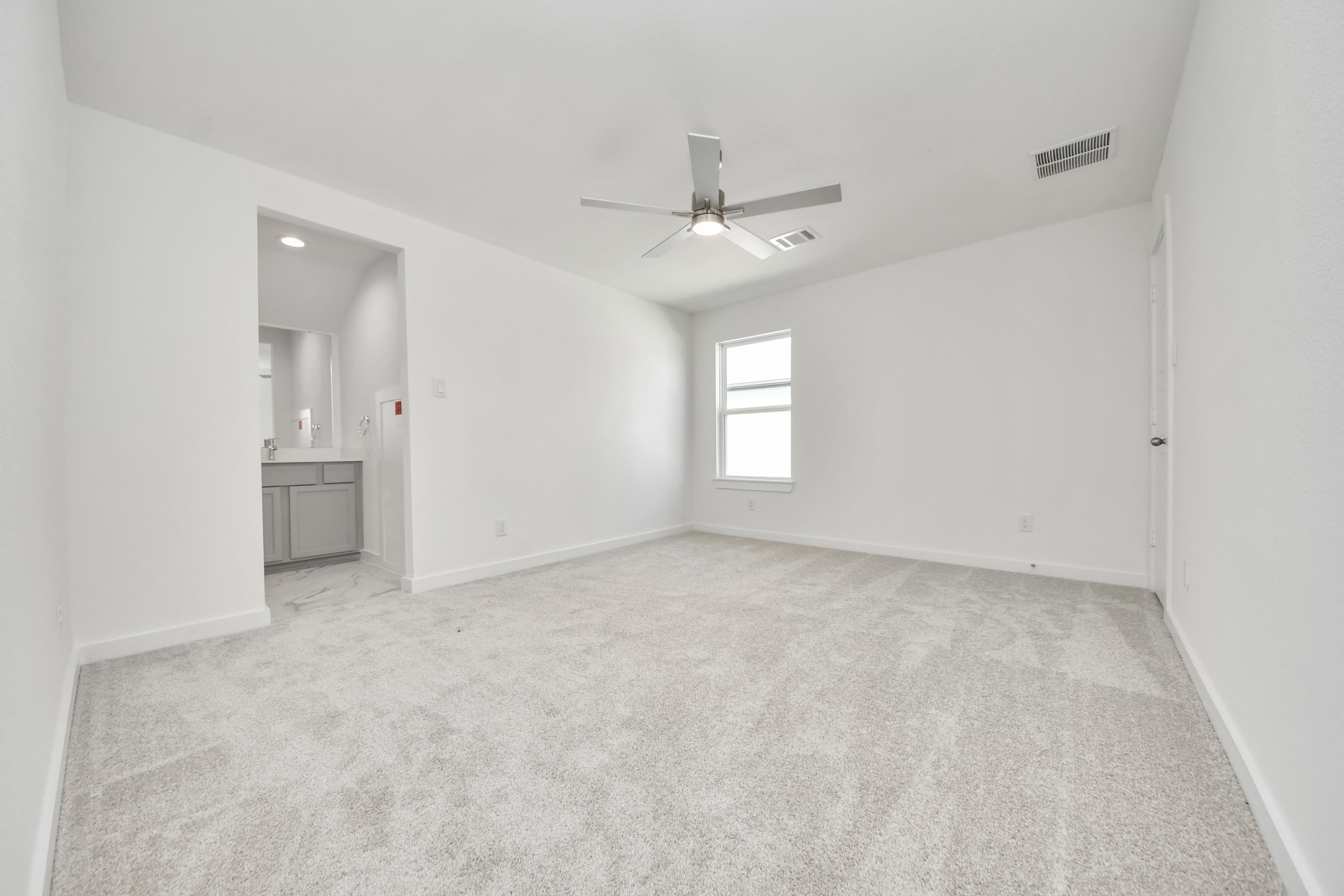 Secondary bedroom features plush carpeting, large windows that let in plenty of natural light, bright paint, and spacious closets.