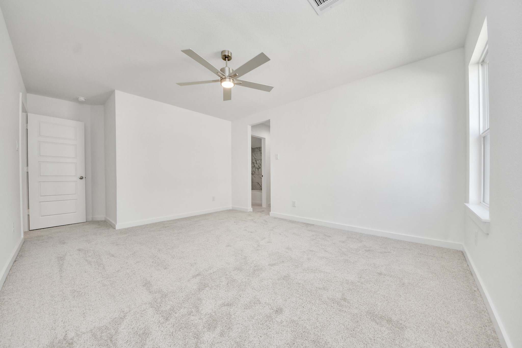 Generously sized secondary bedrooms featuring spacious closets, soft and inviting carpeting underfoot, large windows allowing plenty of natural light, and the added touch of privacy blinds for your personal retreat.