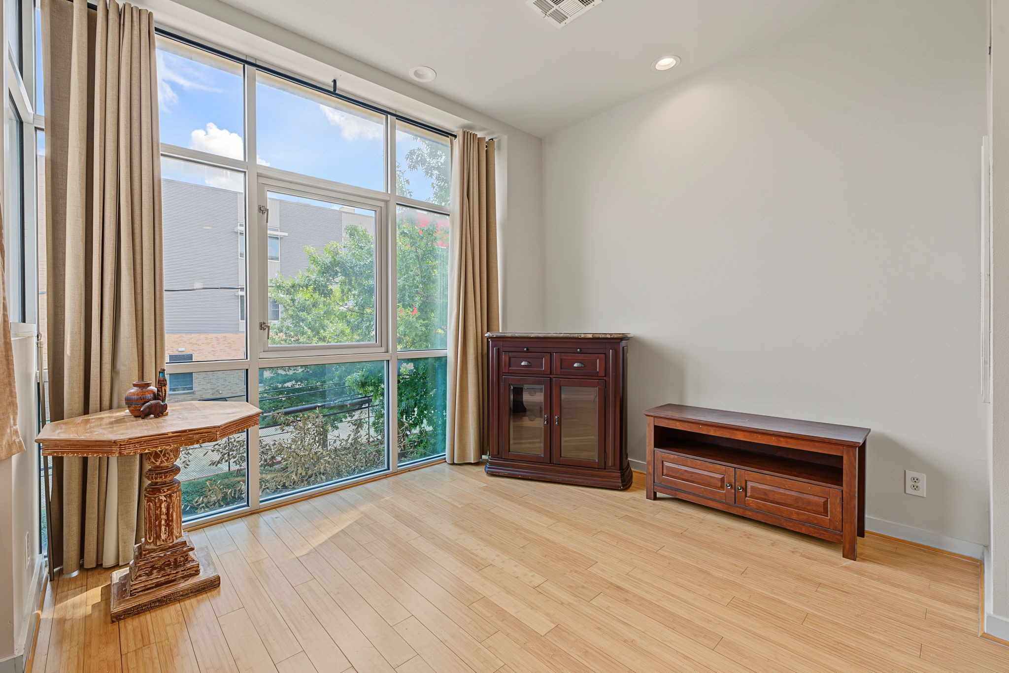 Let the Sunshine In! Dramatic floor-to-ceiling windows bathe the living space with natural light, creating a bright, airy atmosphere that enhances the home's open-concept design. These expansive windows add a striking architectural element while perfectly complementing the condo's sleek, contemporary urban style!