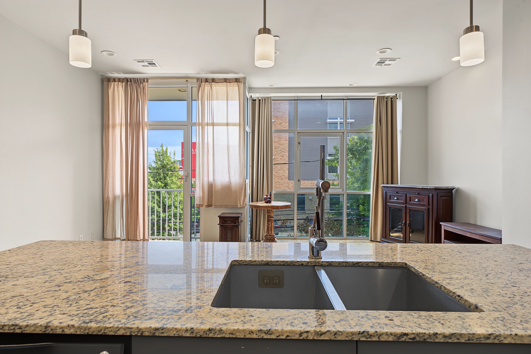 Open to the living room, the expansive kitchen island serves as a natural gathering spot for casual dining, morning coffee, or entertaining guests!