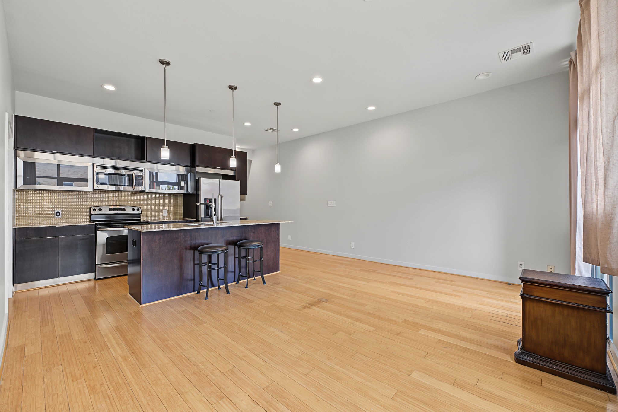 Another view of the kitchen from the living room. Click on the movie reel icon to see an AI-narrated walk-through video of this amazing condo!