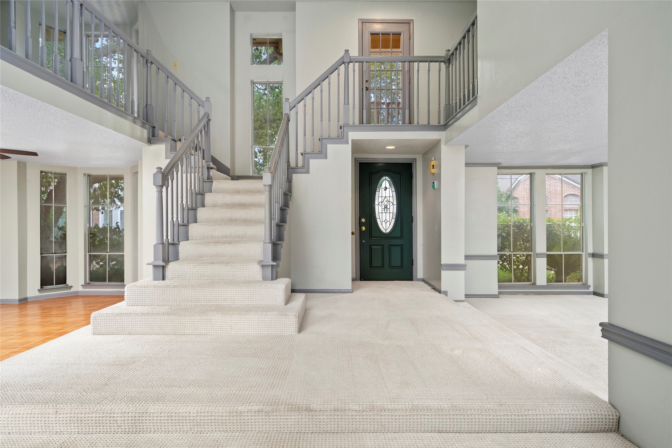 The dramatic two-story foyer, where soaring ceilings and a graceful staircase set an impressive tone the moment you step inside. The dramatic two-story foyer, where soaring ceilings and a graceful staircase set an impressive tone the moment you step inside.