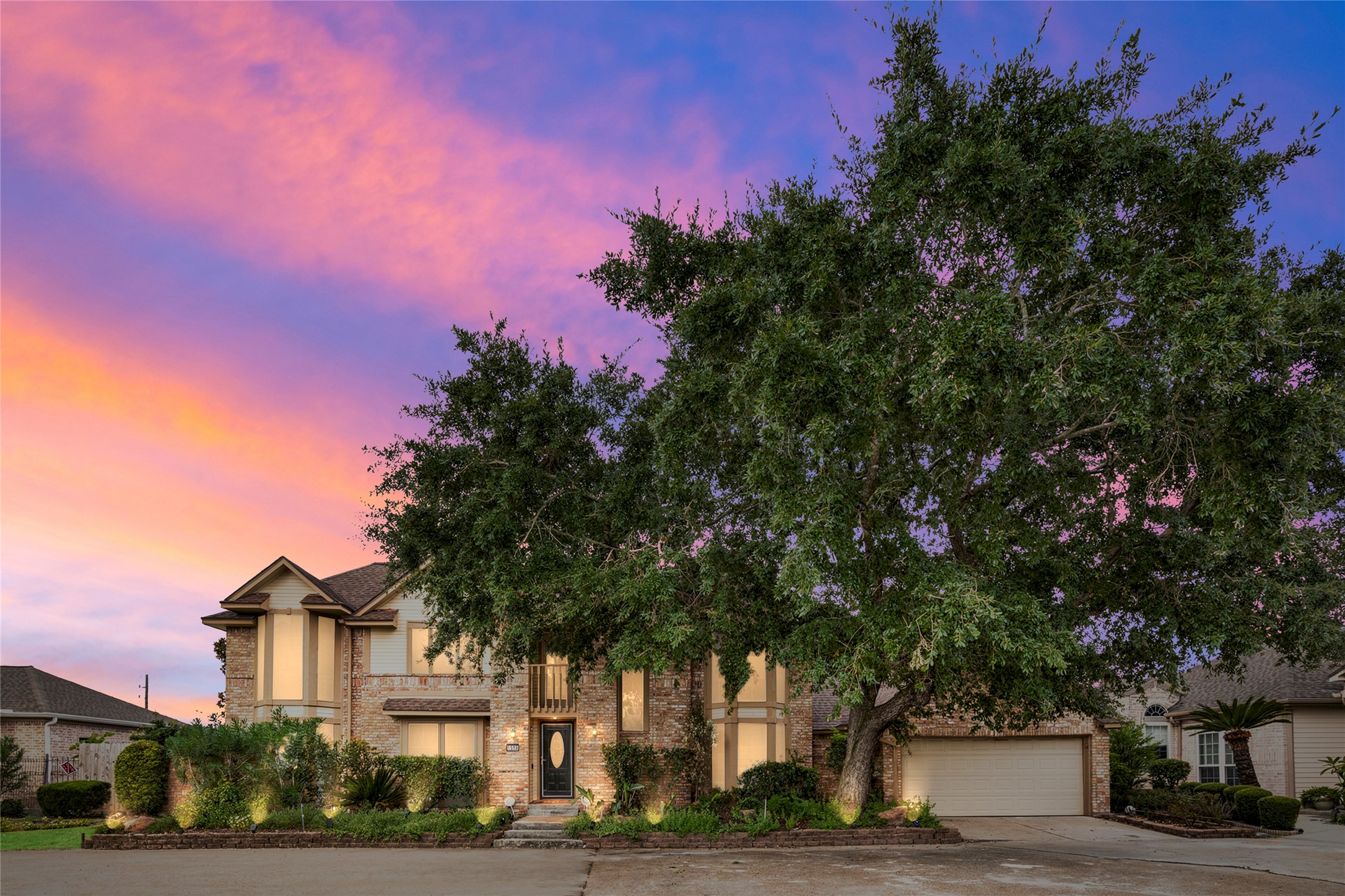 A stunning twilight exterior shot capturing the home bathed in sunset sky, showcasing its curb appeal and commanding presence on the lot as dusk falls. A stunning twilight exterior shot capturing the home bathed in sunset sky, showcasing its curb appeal and commanding presence on the lot as dusk falls.