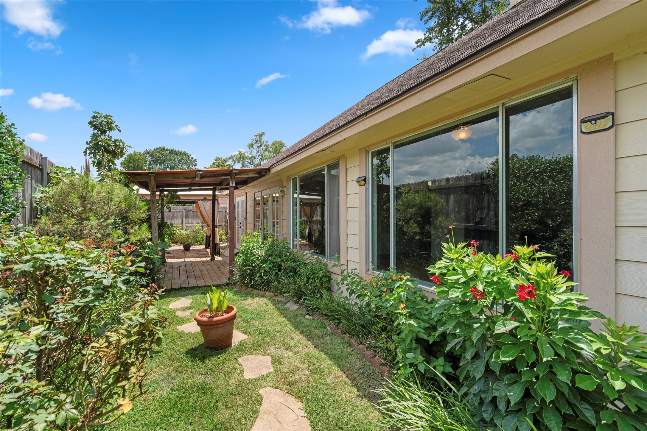 A view of the backyard garden with pergola, showcasing the peaceful, private setting that completes this exceptional outdoor retreat.