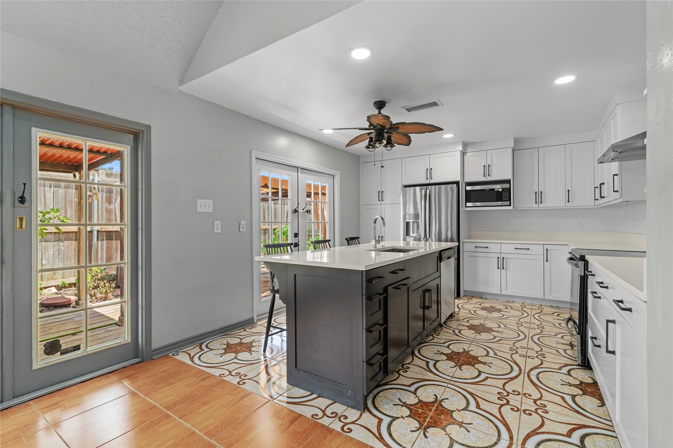 The kitchen, featuring crisp white cabinetry that creates a bright, clean backdrop for cooking and gathering.