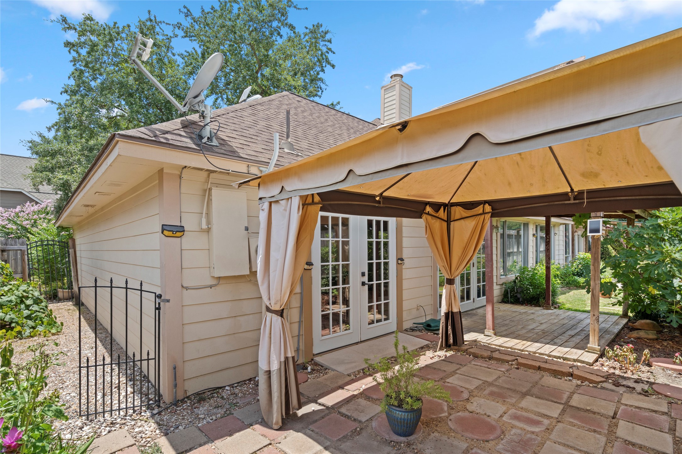 An exterior view of the covered patio, showcasing a shaded outdoor retreat perfect for relaxing year-round.
