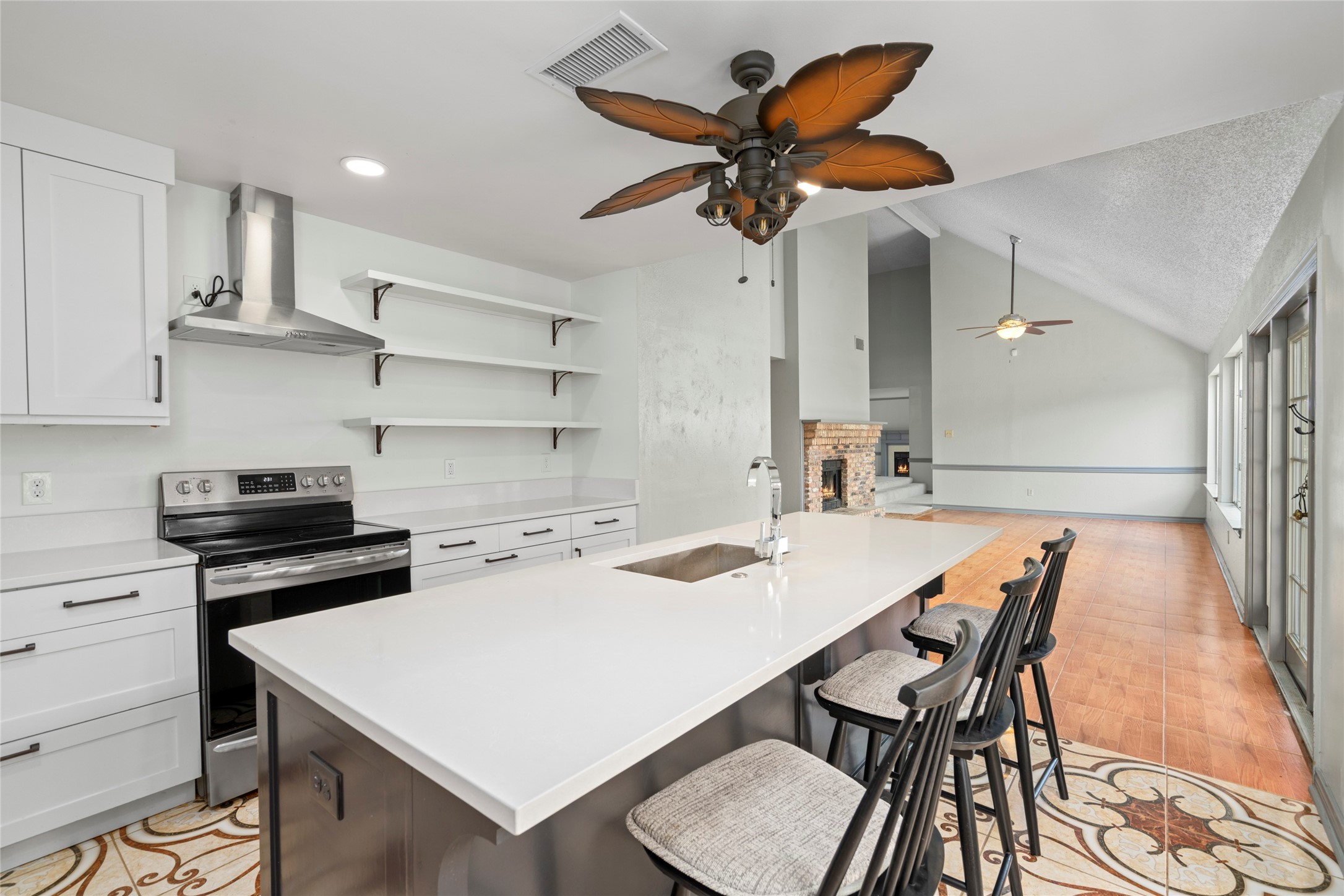 A wide view of the kitchen, capturing the overall layout and how it anchors the main dining and living areas of the home.