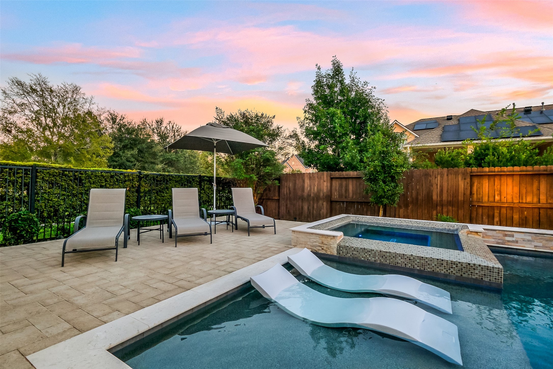 This close up of the pool's tanning ledge and elevated spa showcase the quality of craftsmanship of this outdoor area. Youll love the extra patio space for entertaining and the multiple entertainment areas featured in this back yard. Ledge Loungers can stay with the pool! This close up of the pool's tanning ledge and elevated spa showcase the quality of craftsmanship of this outdoor area. Youll love the extra patio space for entertaining and the multiple entertainment areas featured in this back yard. Ledge Loungers can stay with the pool!