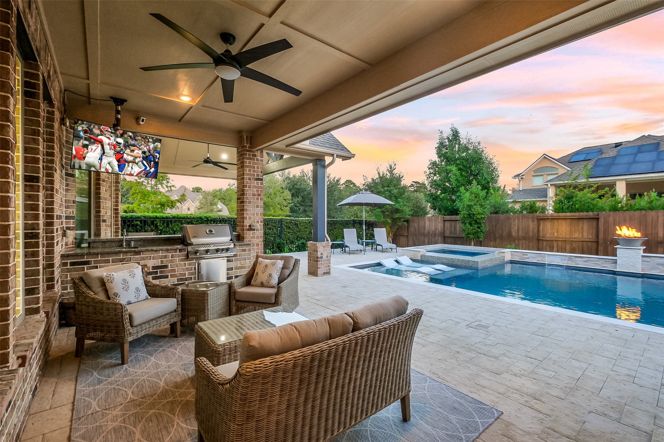 If you love entertaining or feeling like youre on vacation in your back yard, this custom outdoor living space is for you. Featuring a built-in kitchen with a grill and sink, mounted TV, surround sound, ceiling fans and all surrounded by beautiful landscaping and landscape lighting, youll love this extension of your entertaining space. If you love entertaining or feeling like youre on vacation in your back yard, this custom outdoor living space is for you. Featuring a built-in kitchen with a grill and sink, mounted TV, surround sound, ceiling fans and all surrounded by beautiful landscaping and landscape lighting, youll love this extension of your entertaining space.